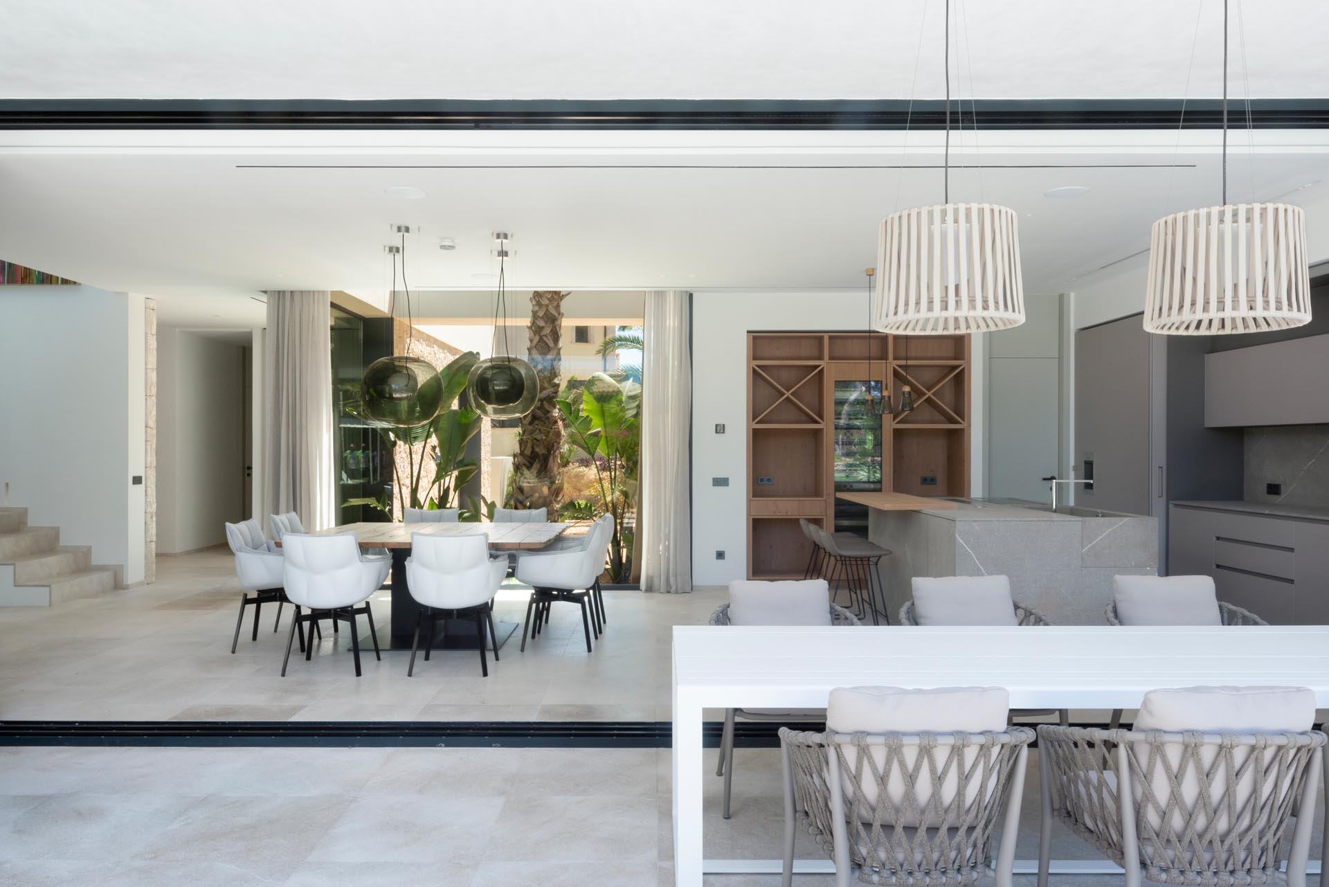 This modern home has large sliding glass walls that connect with the outdoors, creating a single giant entertaining space that's perfect for indoor / outdoor living.