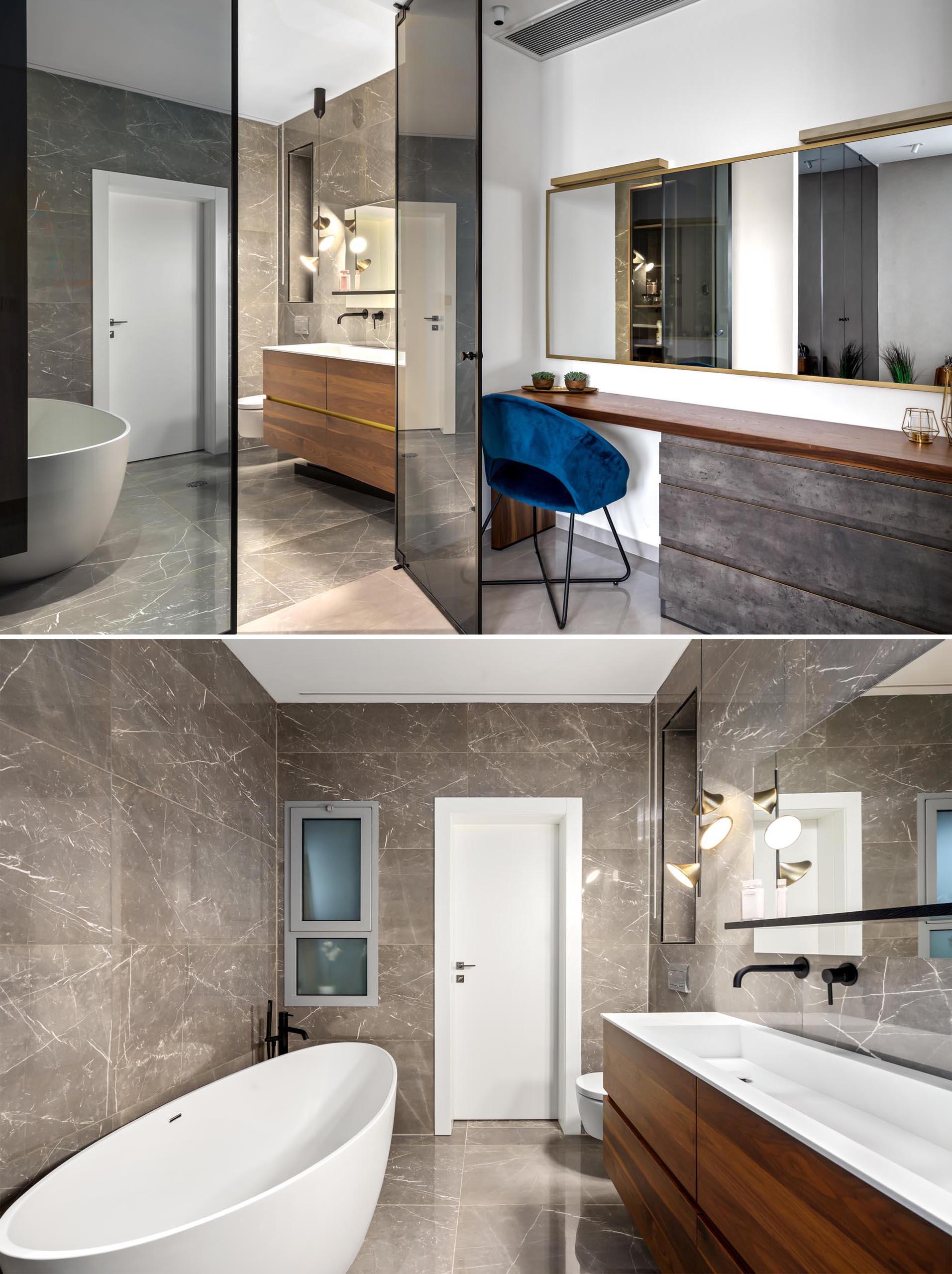 A bedroom with a make-up vanity area and an en-suite bathroom with a freestanding bathtub.