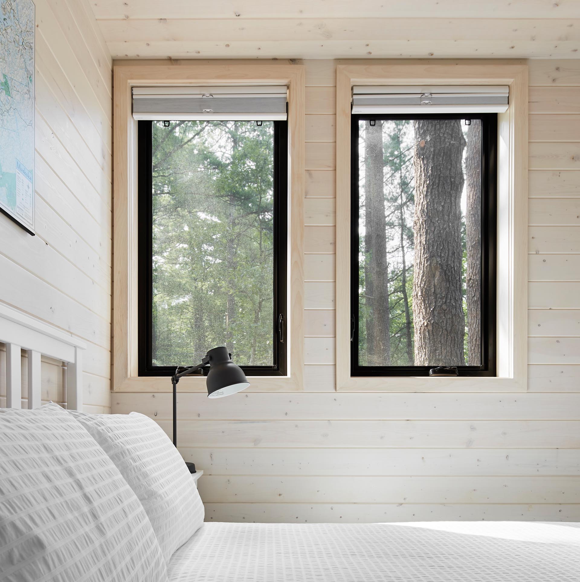 A modern cottage bedroom with black window frames.