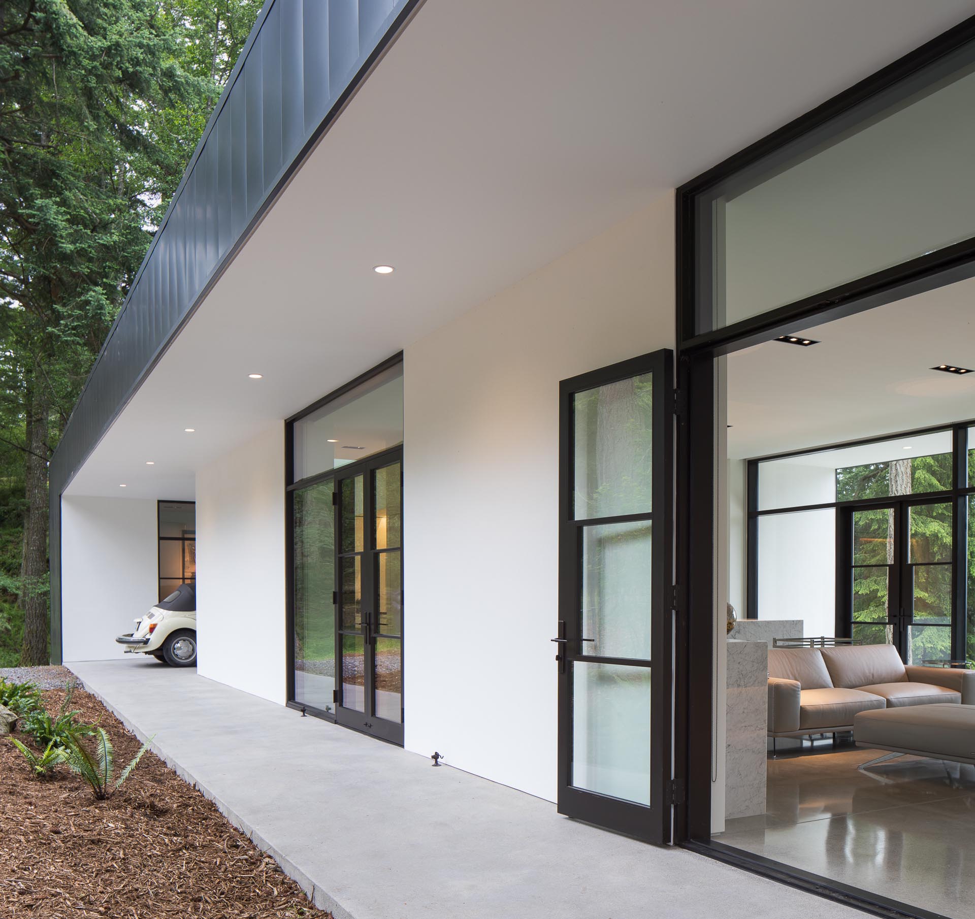 A concrete walkway leads from the carport to the entryway of the home.