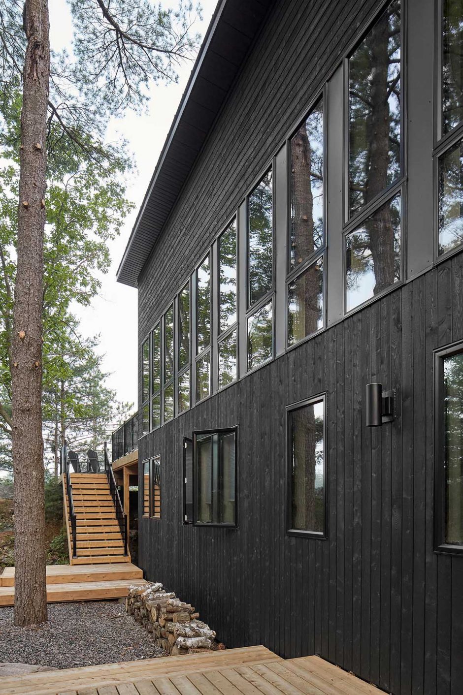 Black Windows Frames Blend Into The Black Wood Siding On The Exterior