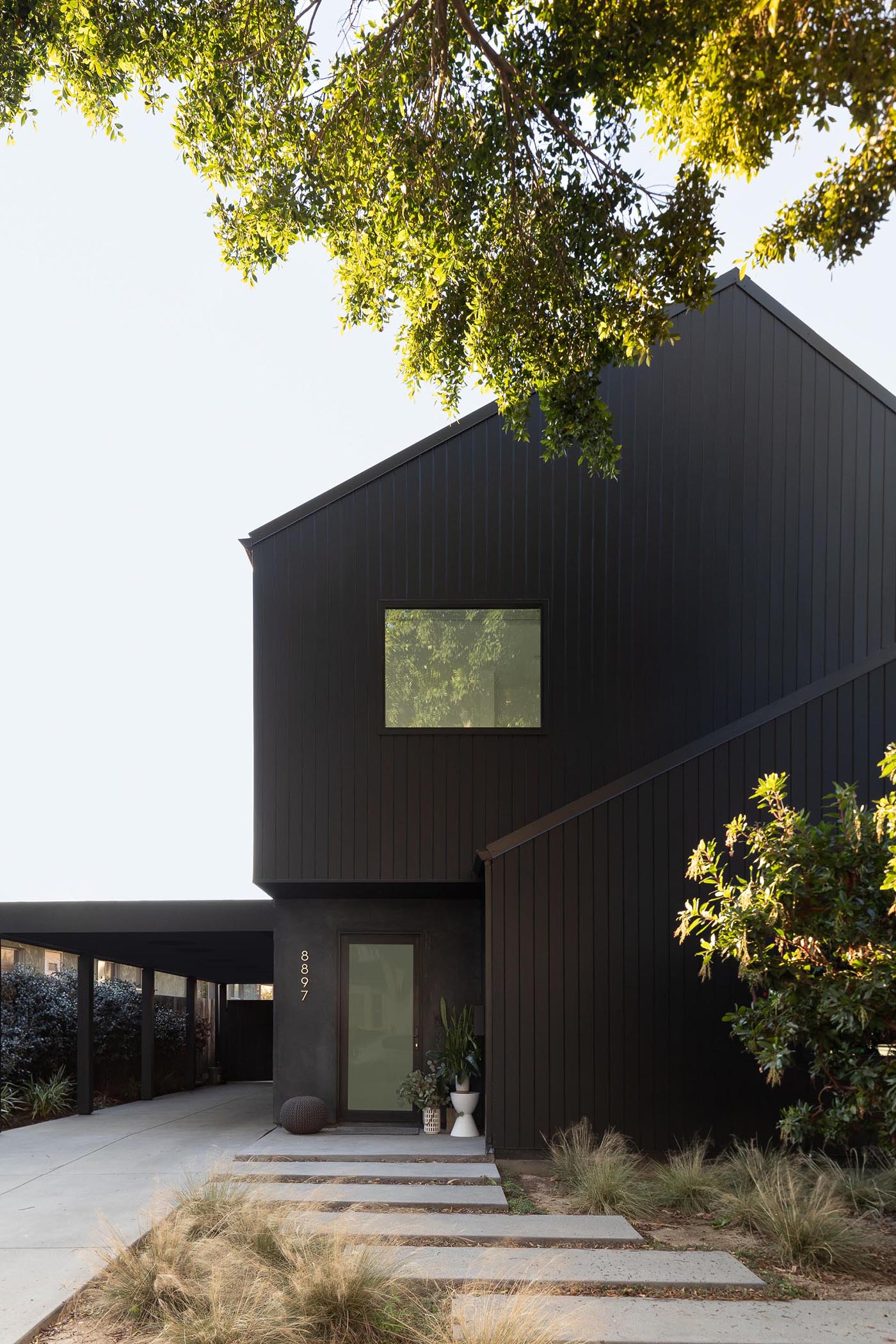 The dark and moody black exterior of this modern home was inspired by Japanese traditions like Shou Sugi Ban, while the design of the home evokes the familiar footprint of a traditional barn.