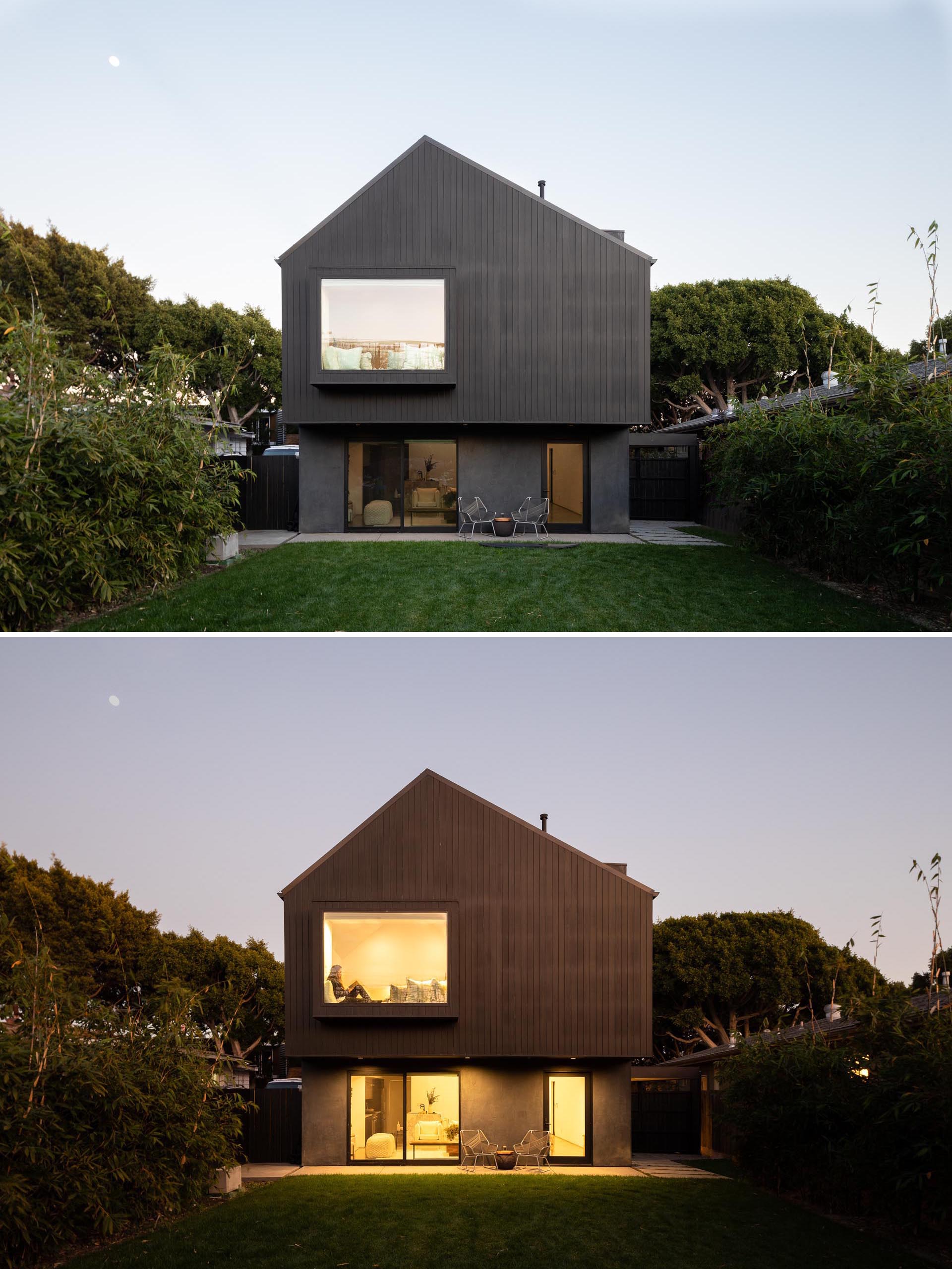 The rear of this home shows how the upper floor of the home hangs over the lower half, while a protruding window makes room for a window seat on the interior.