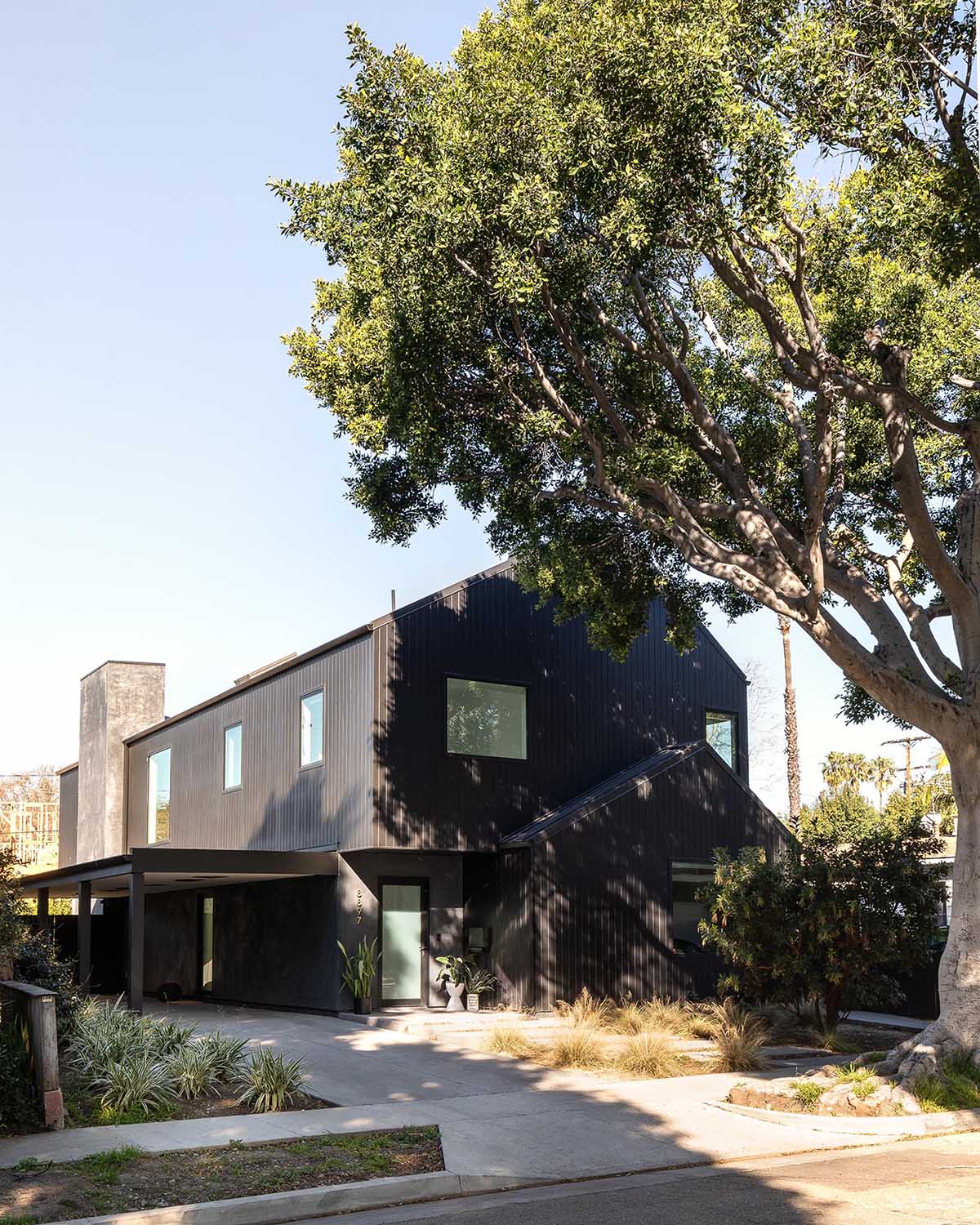 The dark and moody black exterior of this modern home was inspired by Japanese traditions like Shou Sugi Ban, while the design of the home evokes the familiar footprint of a traditional barn.