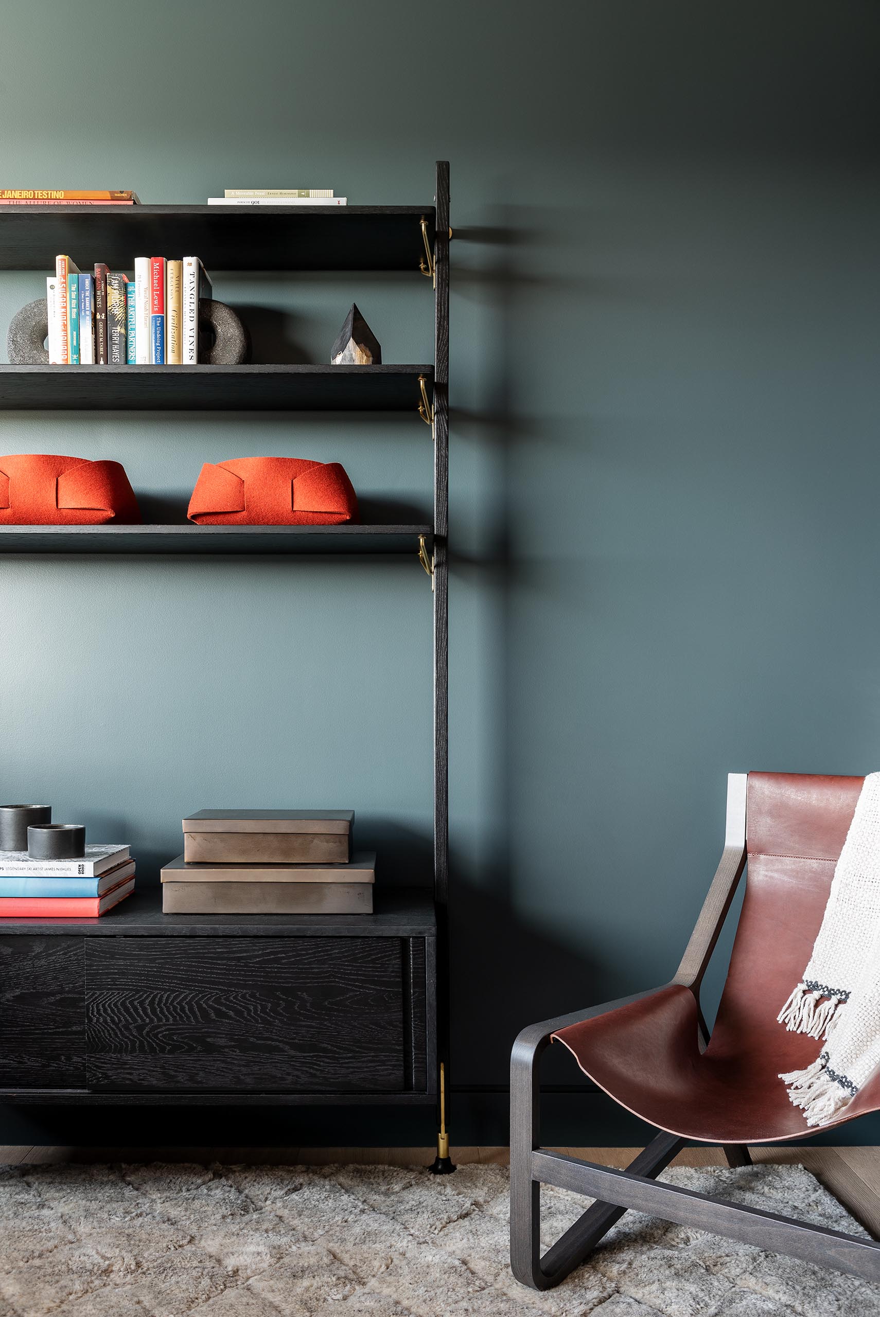 A modern living room with a bold blue-gray accent wall.