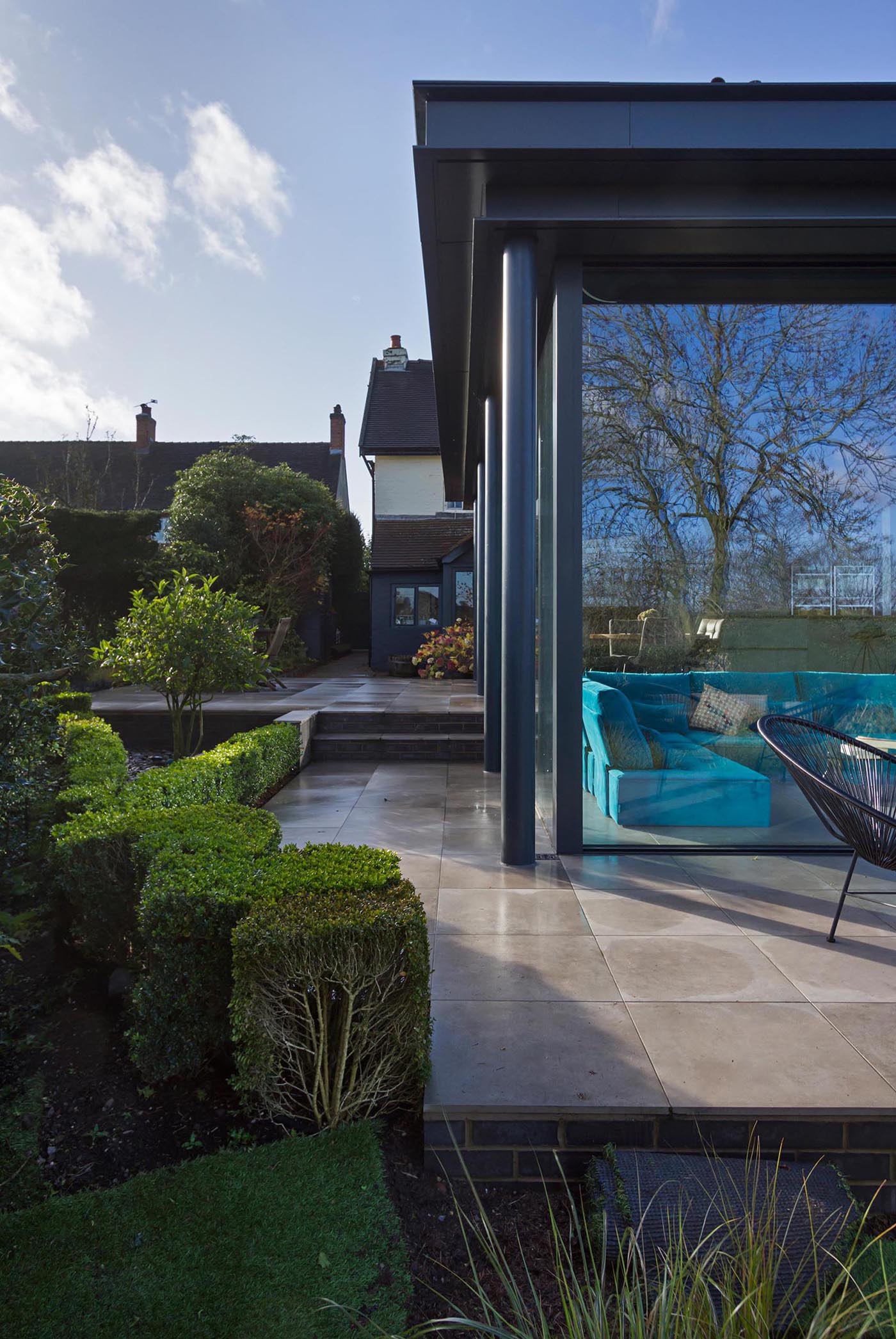 A modern extension with glass walls also has a wrap-around patio.