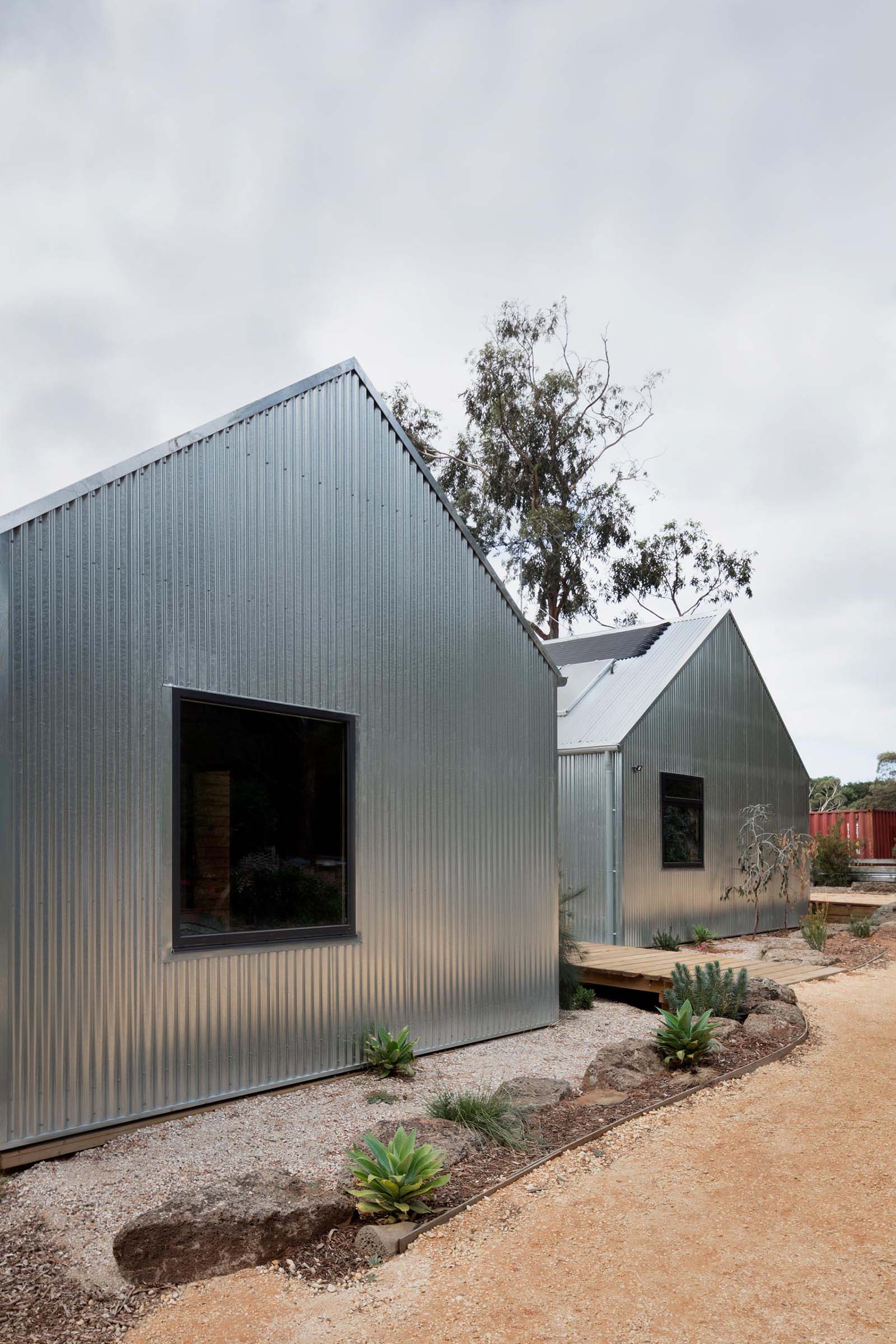 Corrugated steel siding, which covers the entire home, is designed change appearance as it ages, creating a dull finish.