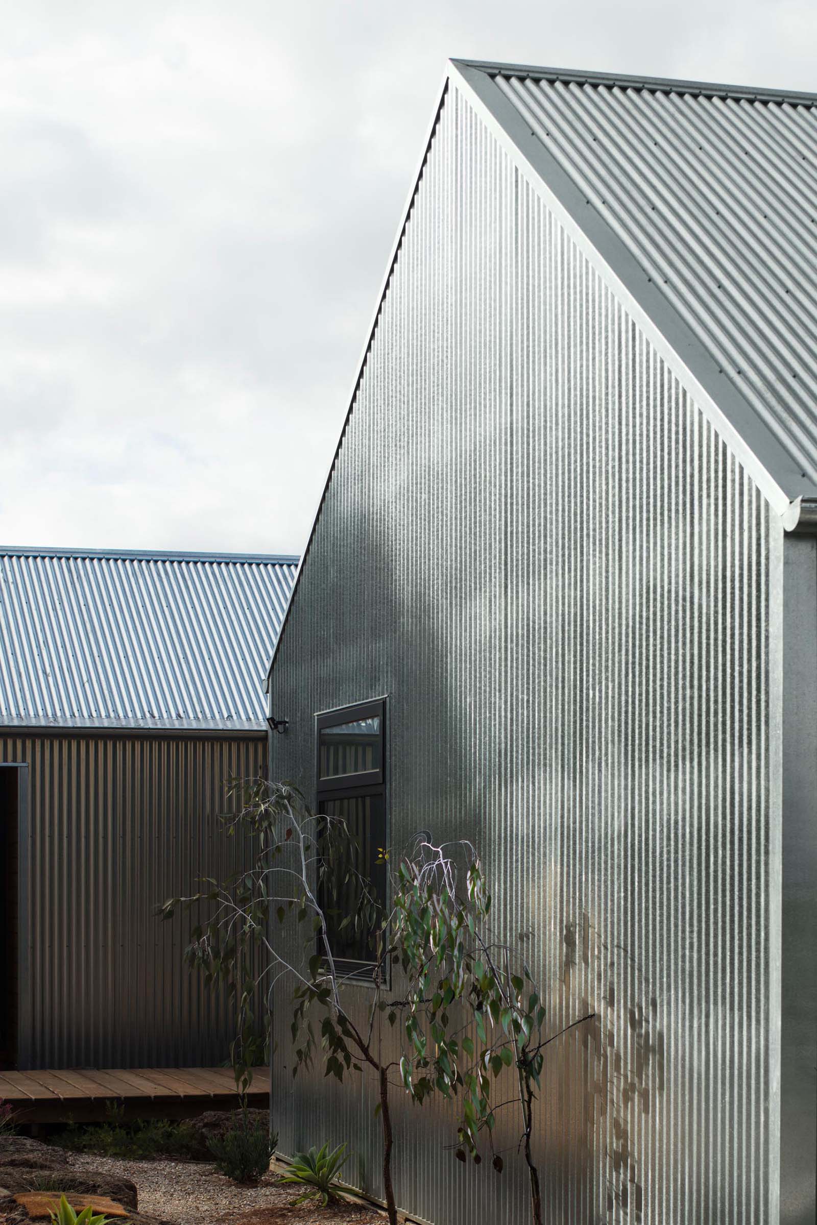 The hard exterior of corrugated galvanised steel sheeting, which covers this entire home, is designed change appearance as it ages, creating a dull finish.