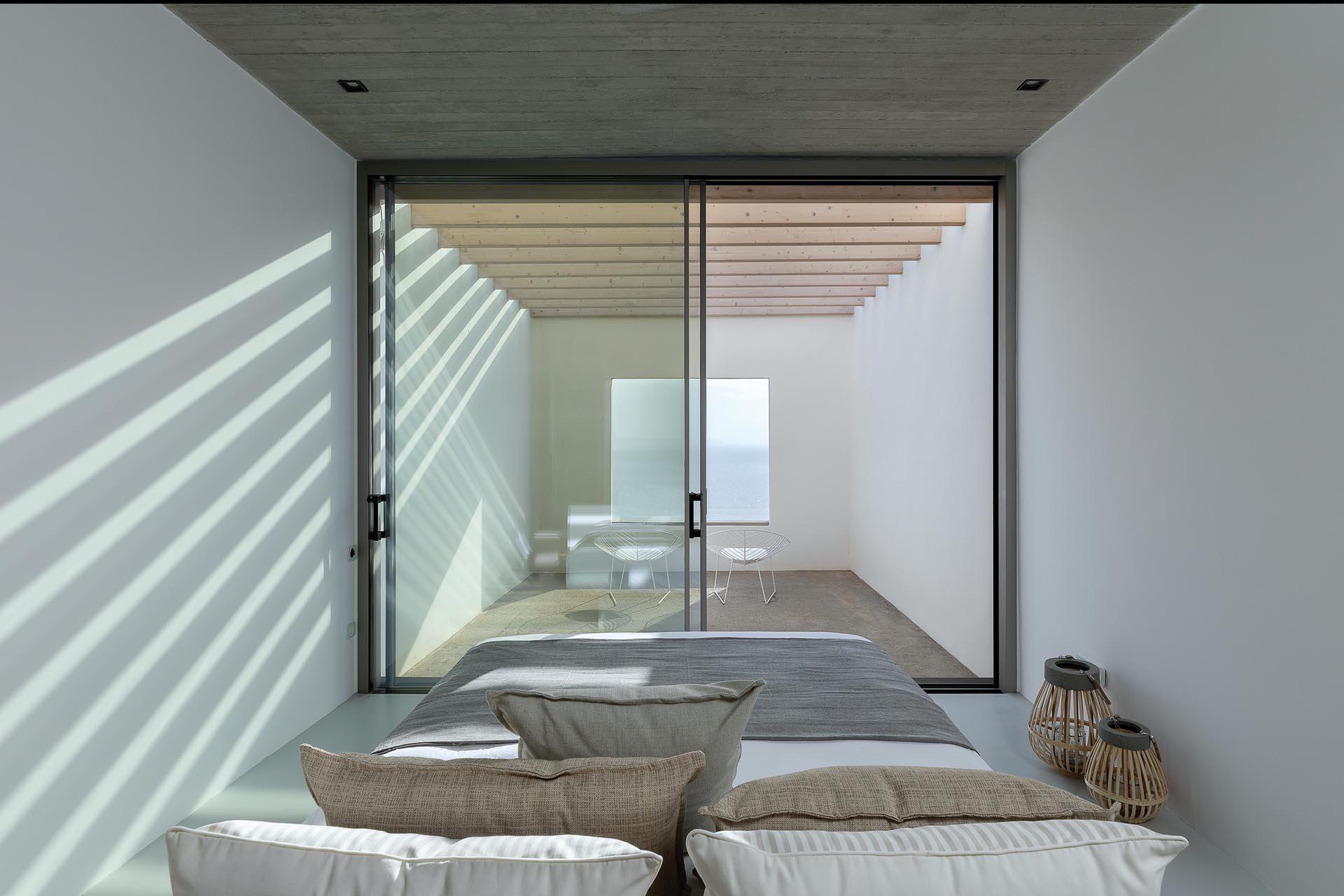 A modern bedroom with its own private outdoor patio.