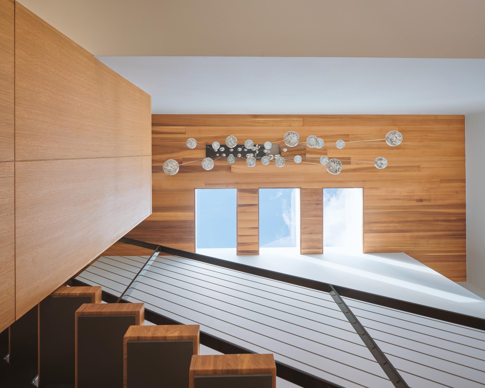 A modern wood ceiling with three skylights.