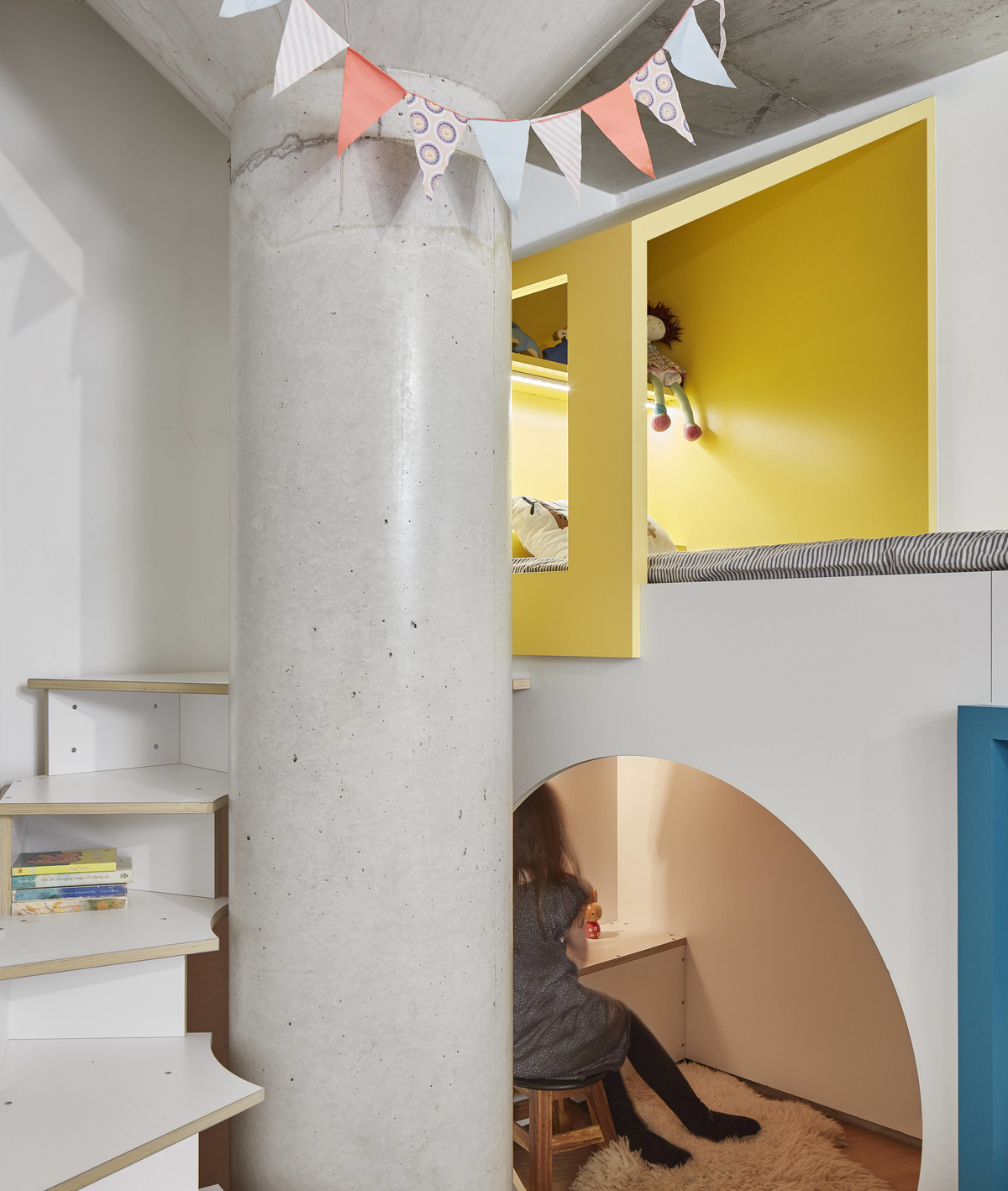 A custom designed bedroom with storage and two small staircases that connect the beds with play areas.