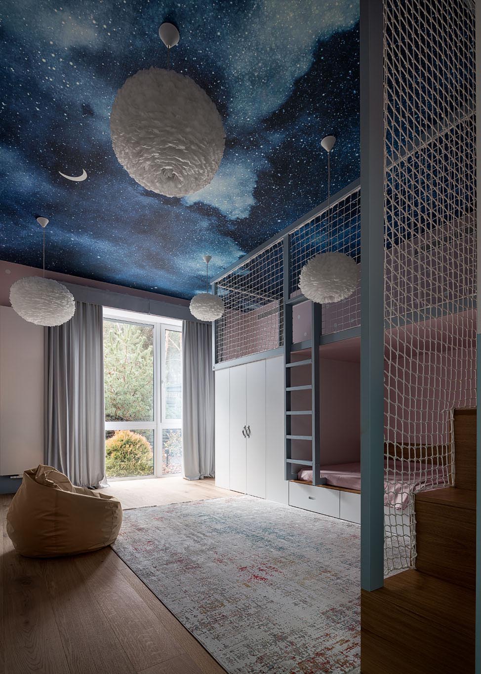 The bedroom ceiling of this kid's room has been decorated with a night sky mural and delicate white pendant lights of different sizes.