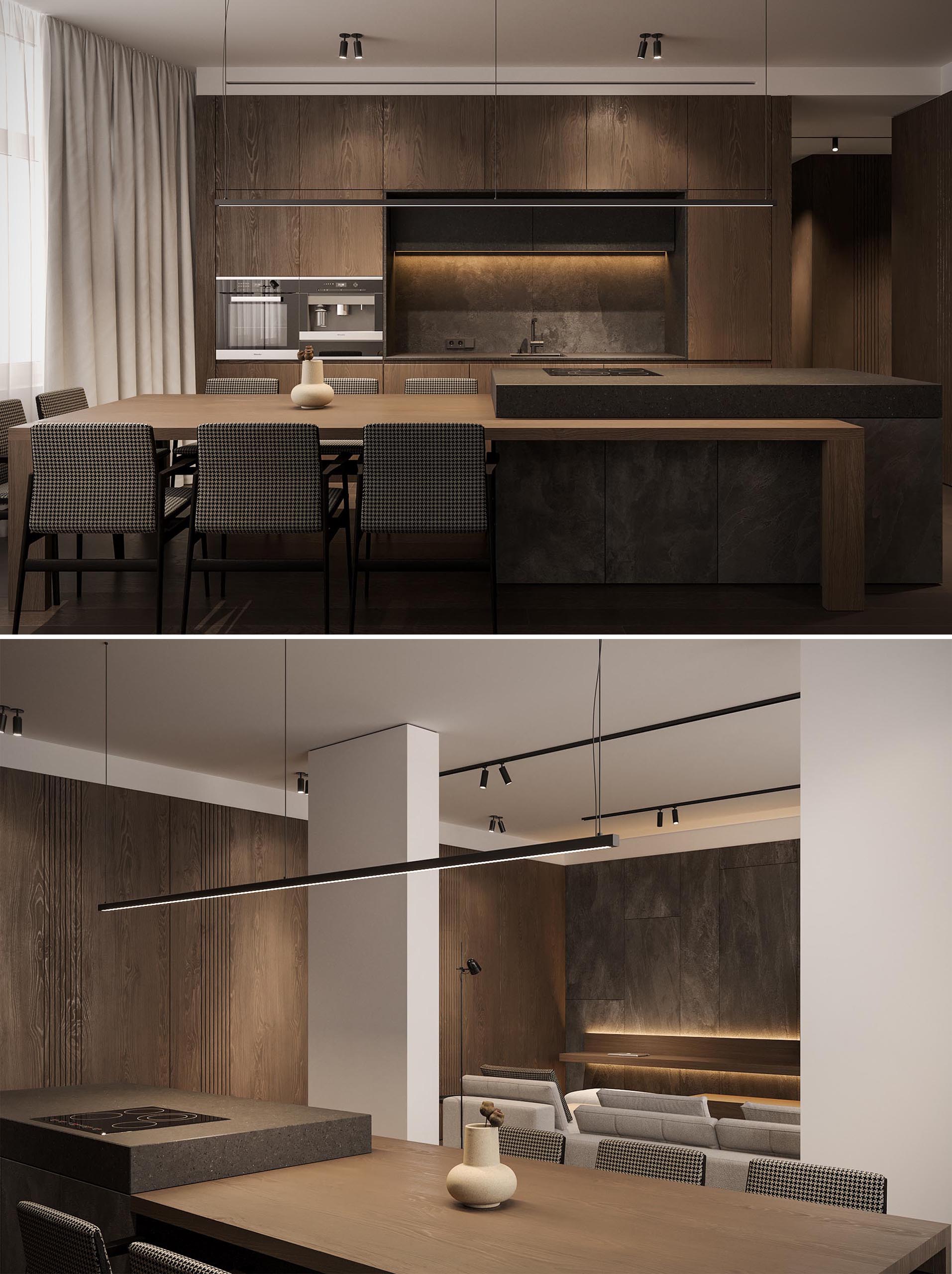 A spacious wood kitchen with black accents has a large island with an extension for seating 8 people.