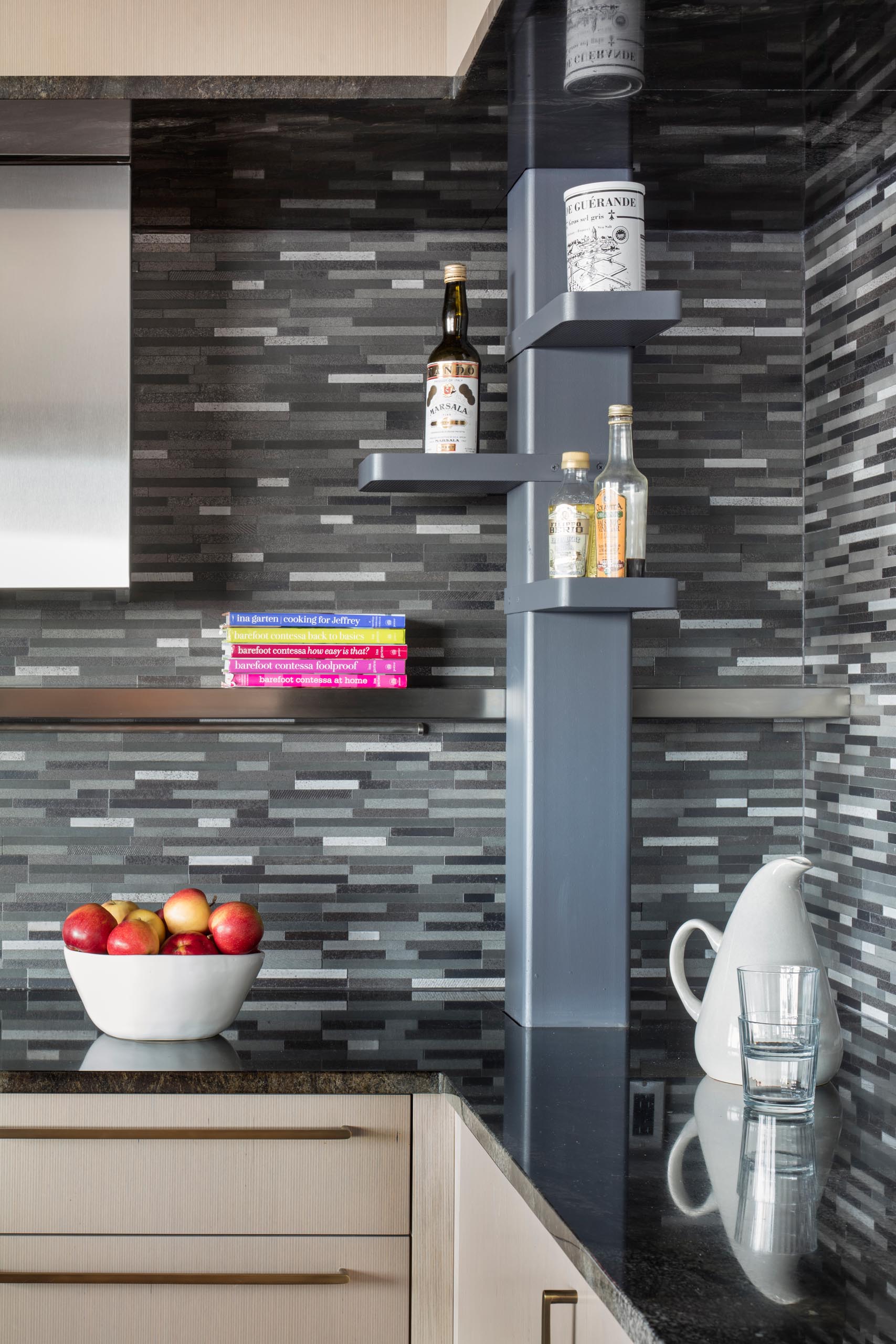 A modern kitchen with a gray tile backsplash.