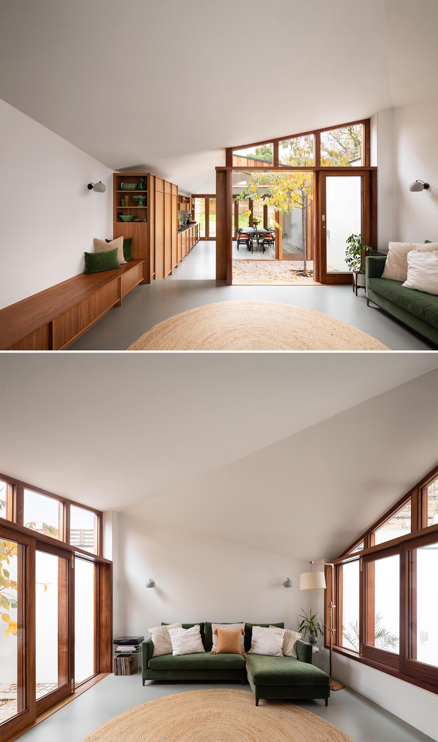 Separating the dining room / kitchen and the minimalist living room of this modern home extension is a small courtyard with a tree that's accessed by a collection of sliding doors.