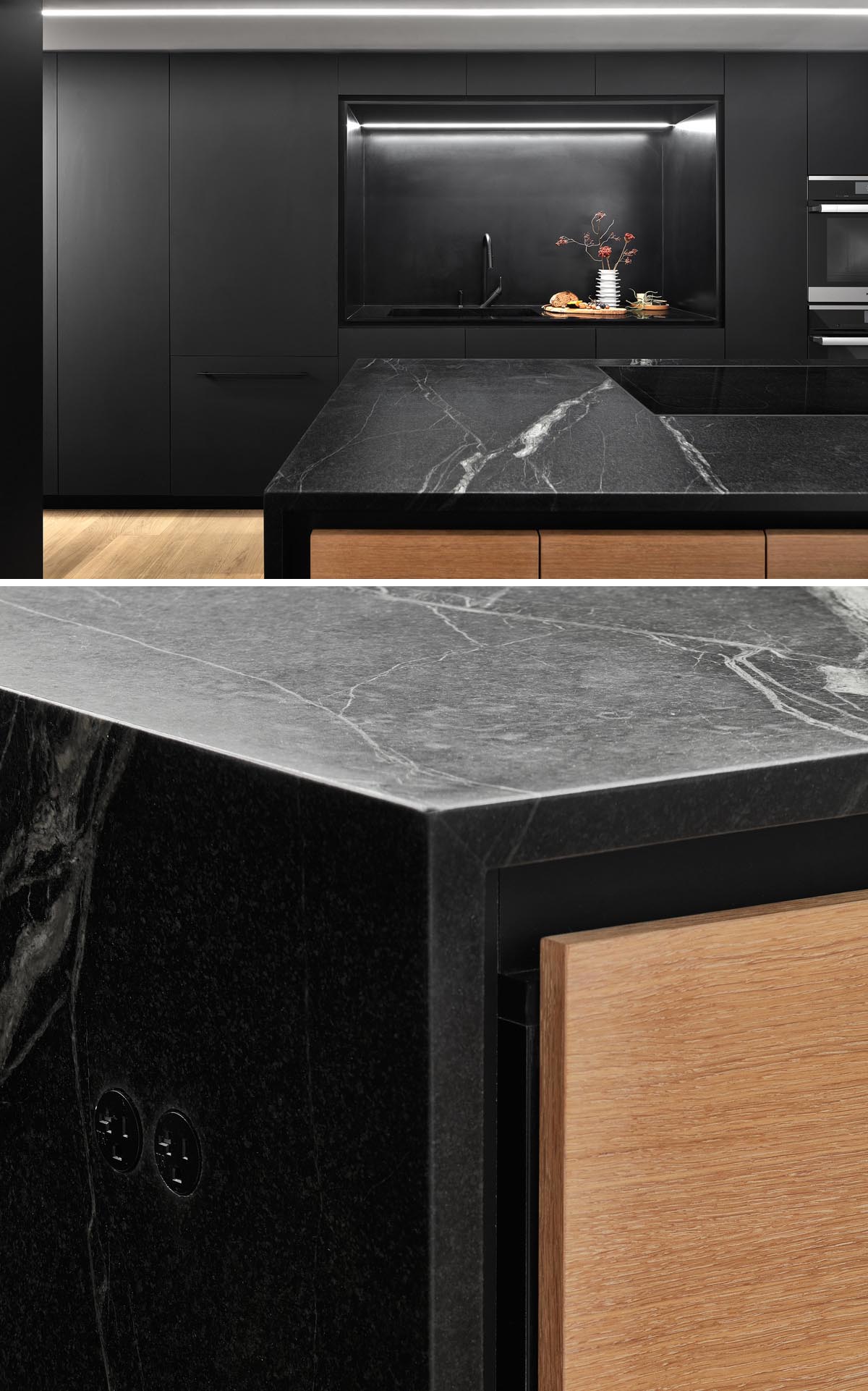 A modern matte black kitchen with hardware free cabinets and a large island with wood accents.