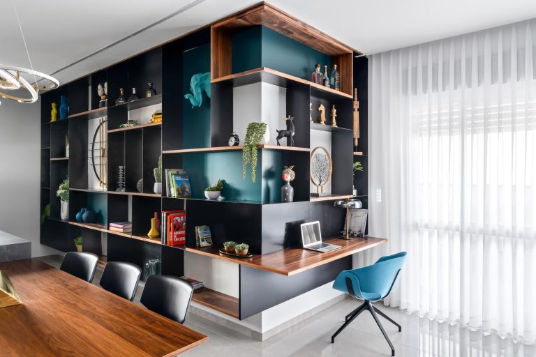 A Small Desk Was Included In This Wrap Around Wall Of Shelving Designed To Show Off Decor Pieces