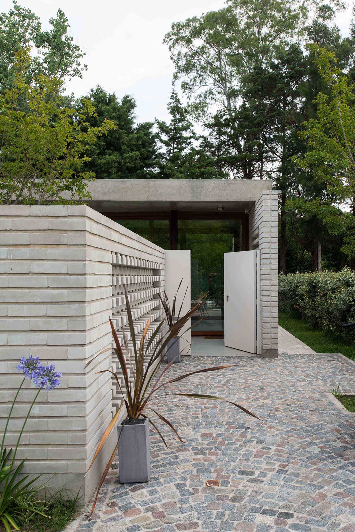 A concrete block wall that provides privacy for a modern home.