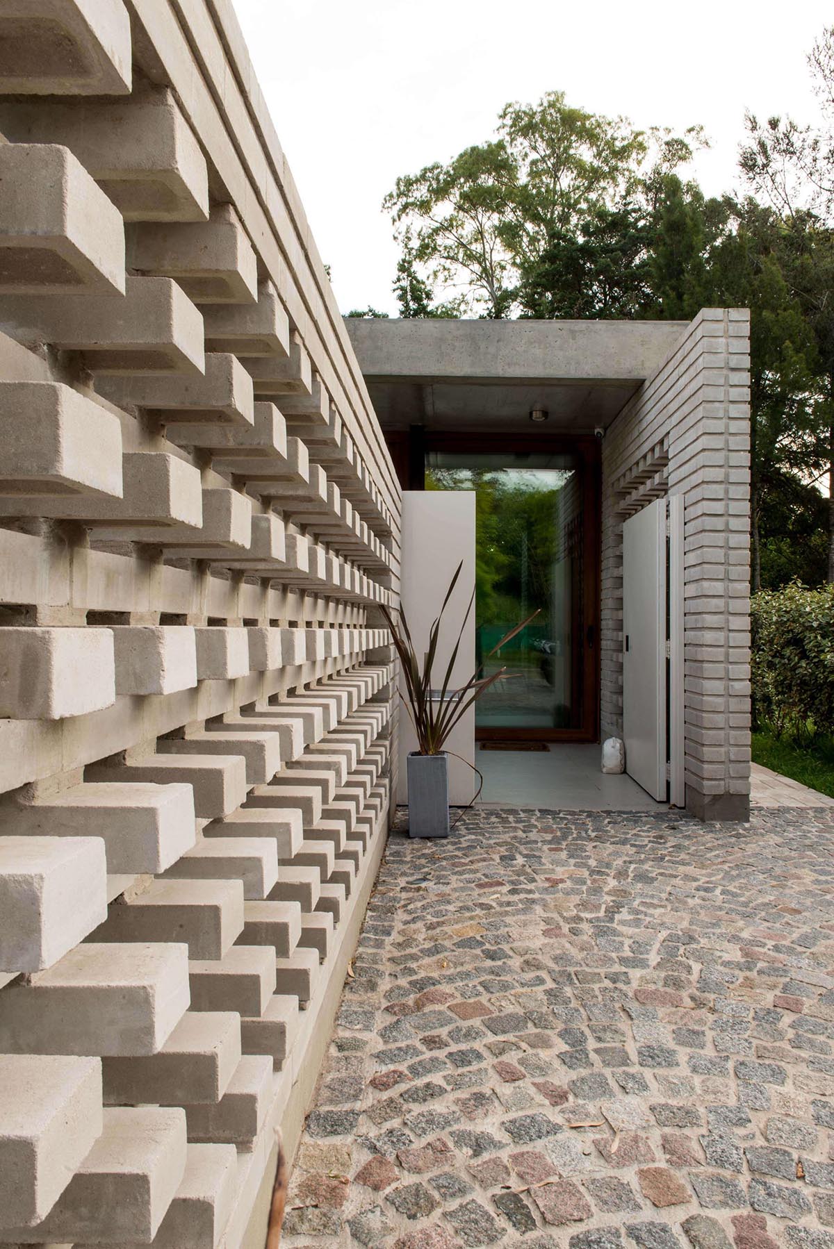 A concrete block wall that provides privacy for a modern home.