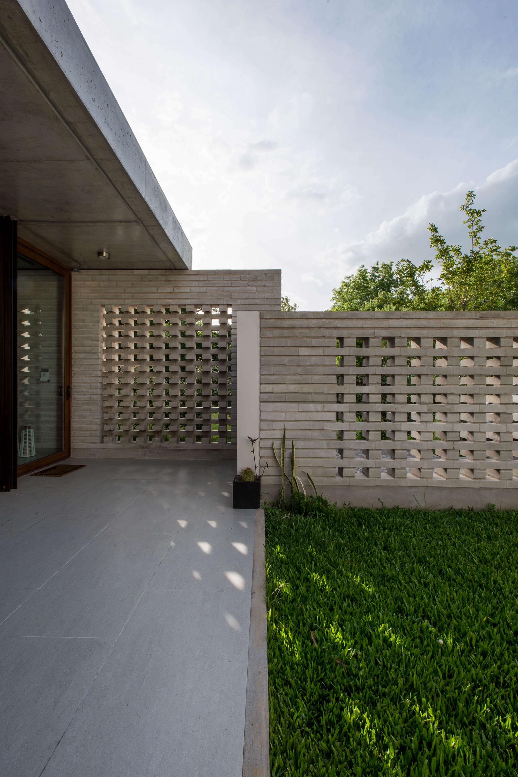 A concrete block wall that provides privacy for a modern home.