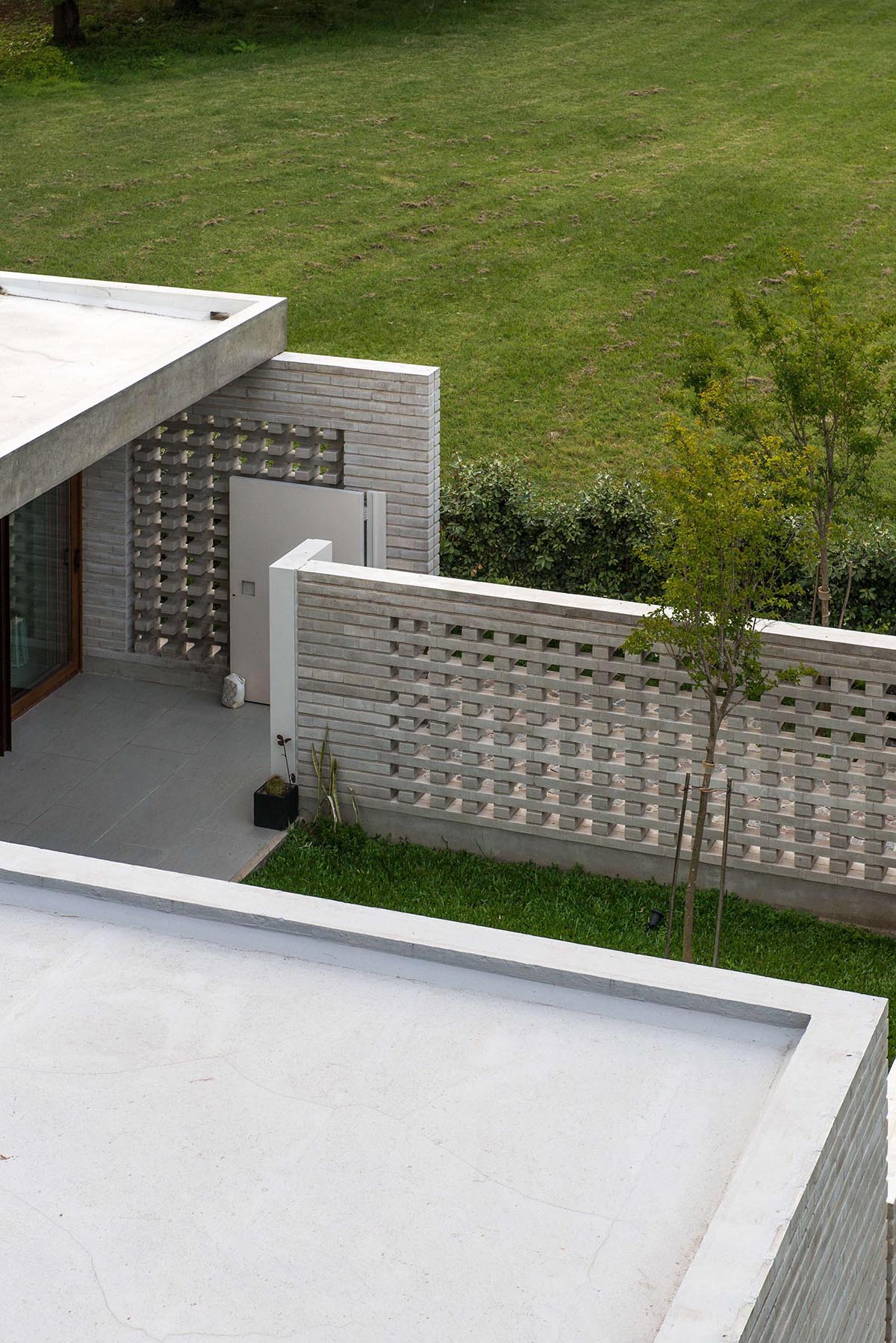 A closeup look at a concrete block wall that provides privacy for a modern home.