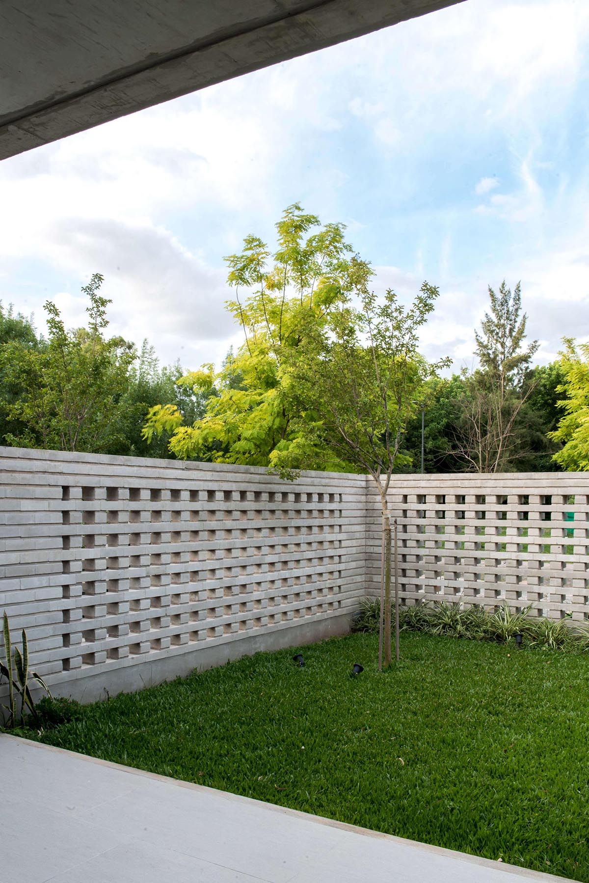 A closeup look at a modern concrete block fence that provides privacy for a home.