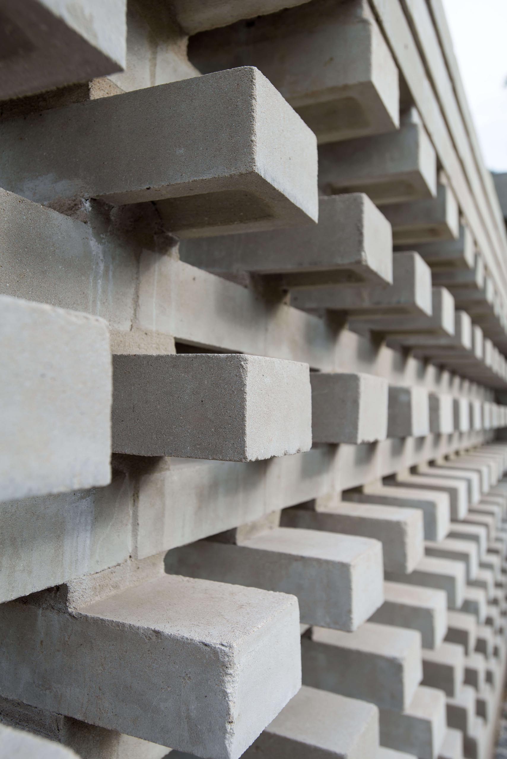 A closeup look at a modern concrete block wall that provides privacy for a home.