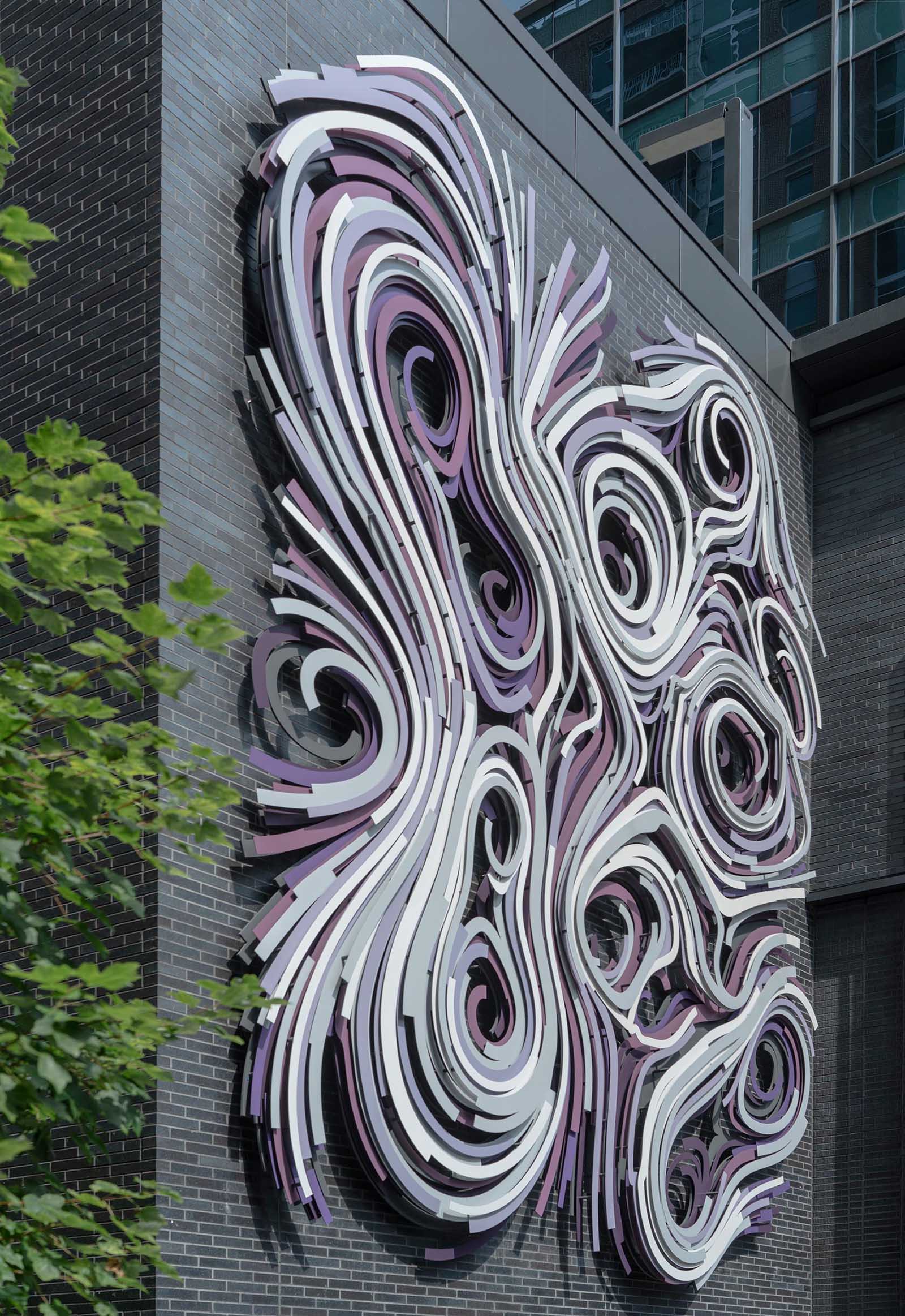 A modern large scale mural on the side of a building.