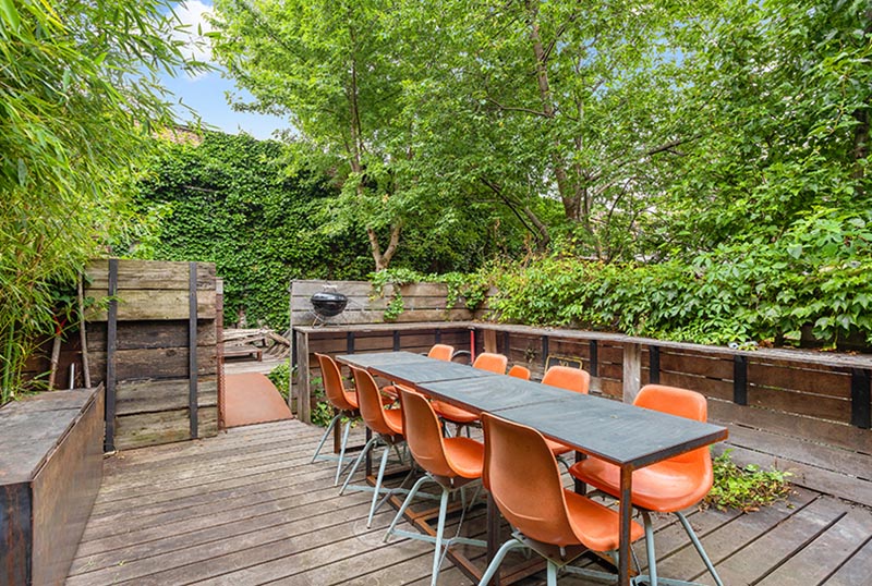 An outdoor dining area surrounded by plants.