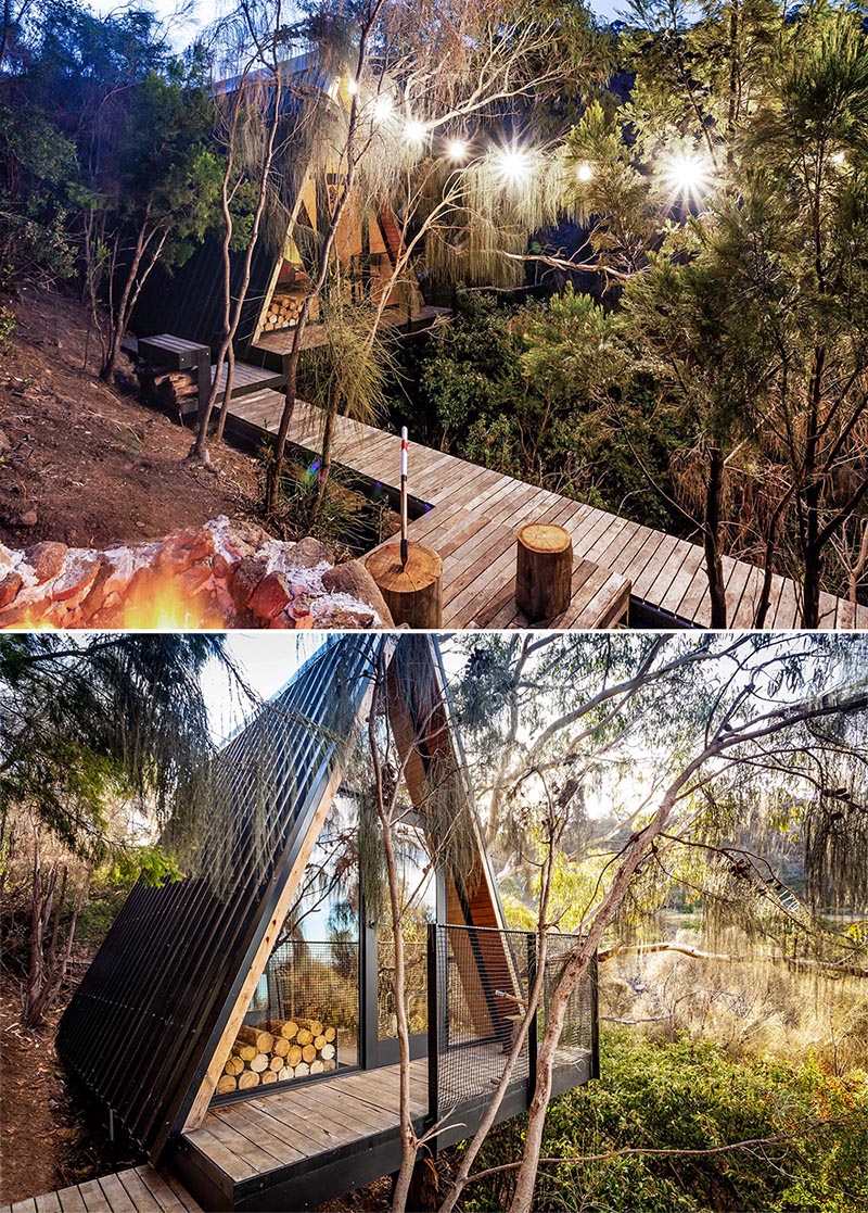 A small and modern A-framed cabin with black metal roofing and a wood interior.