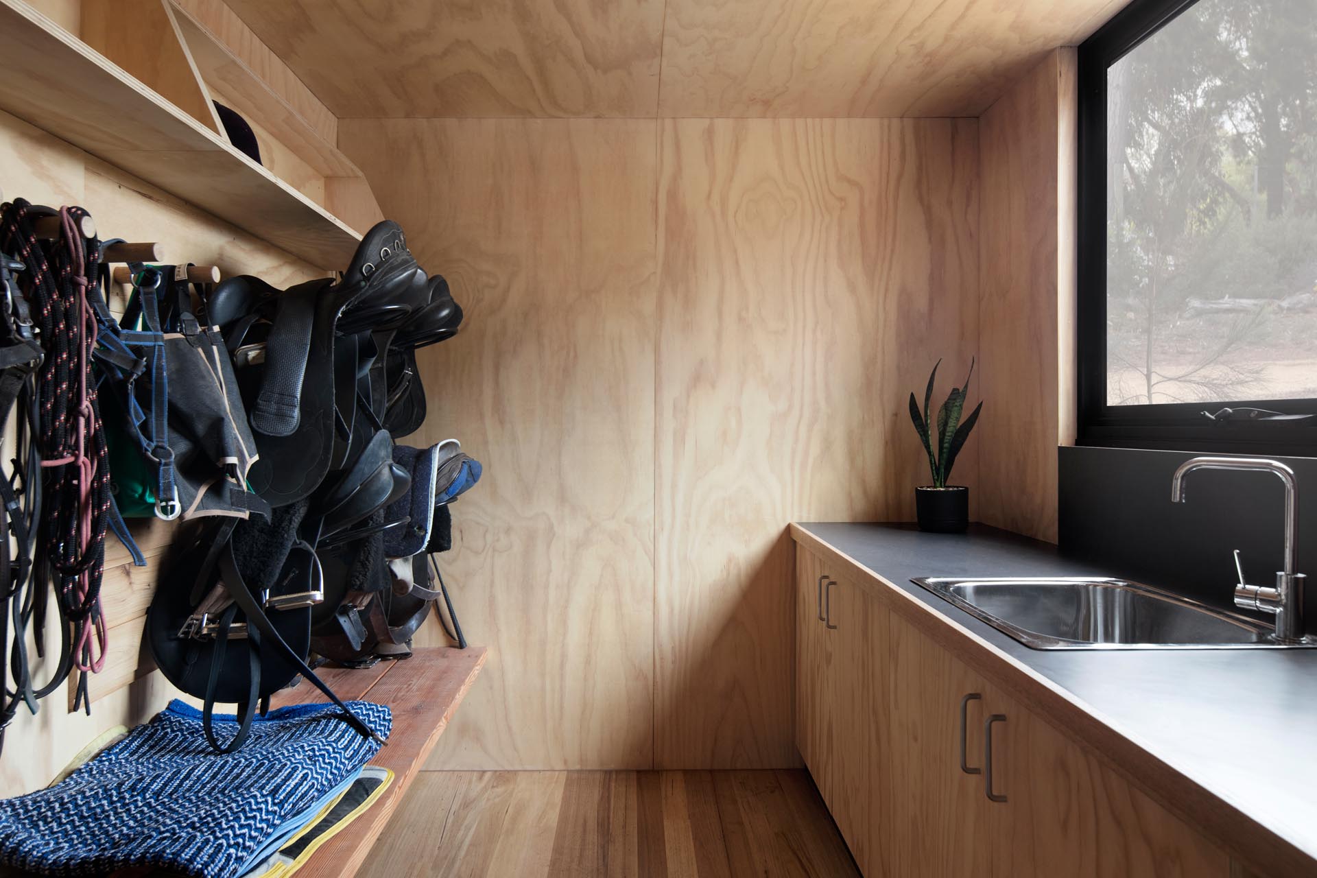 A rural home with a tack room for keeping saddles.