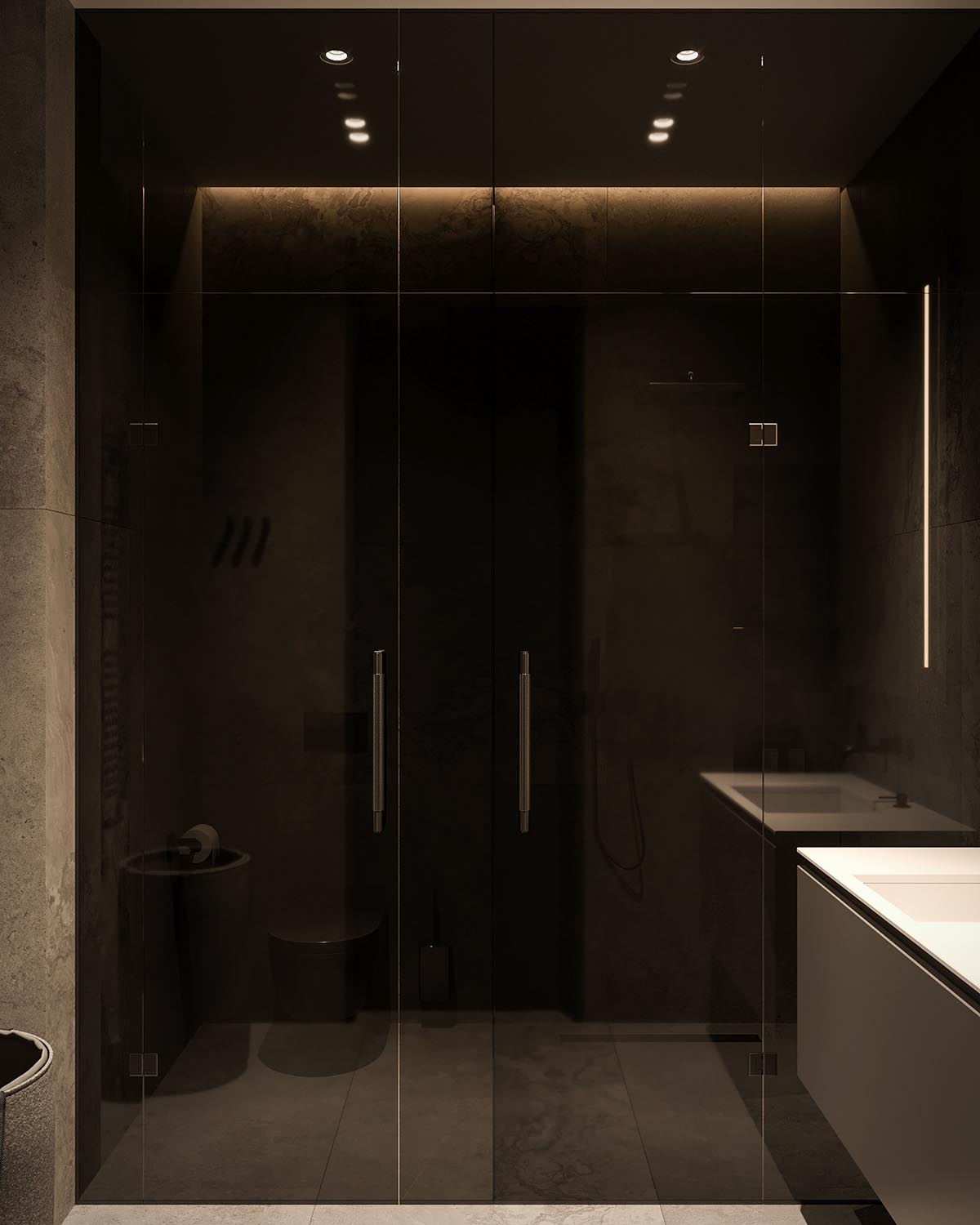 A modern bathroom with a white vanity, large format tiles, and black accents, like a tinted glass shower door.