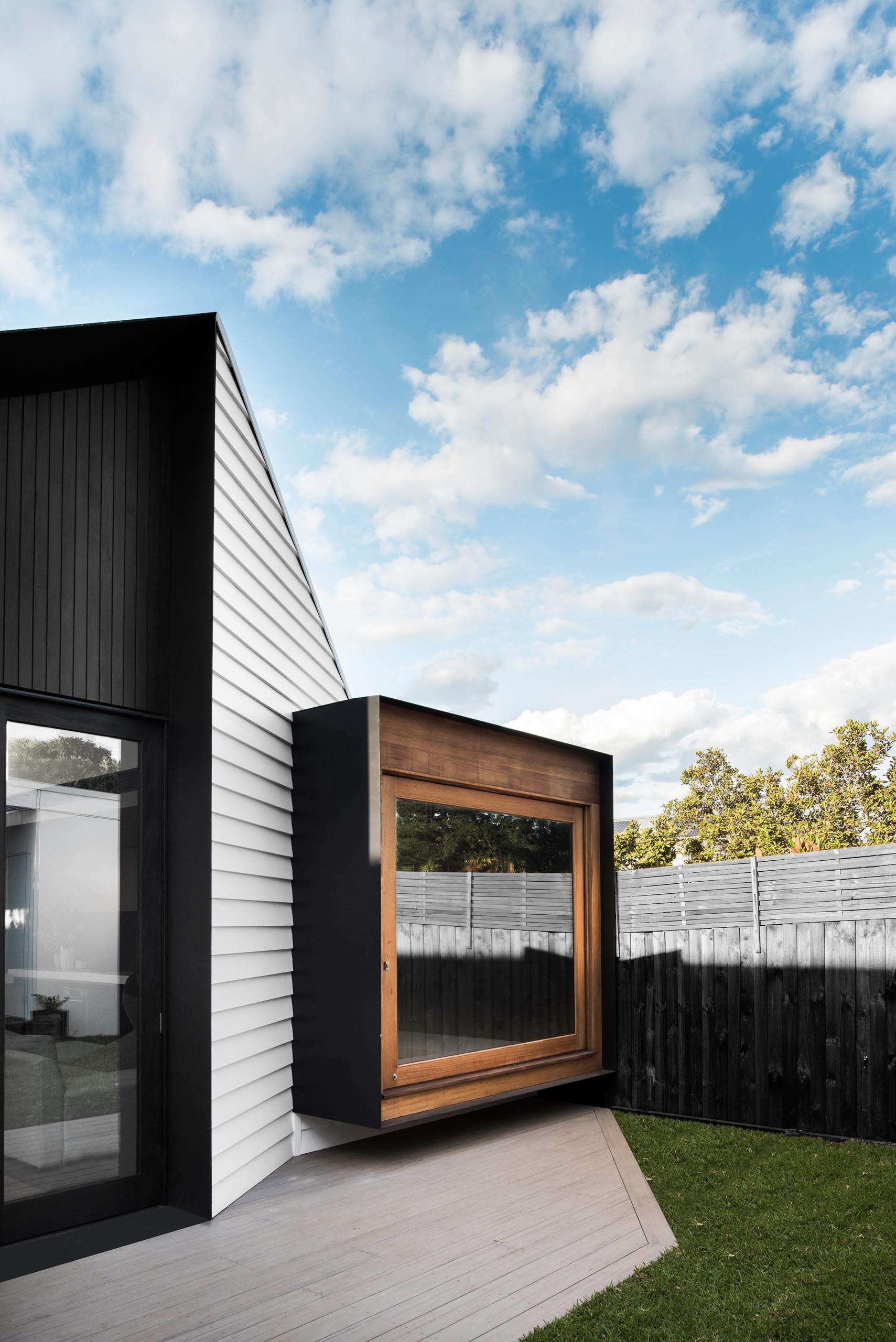 A large pivoting wood framed window.