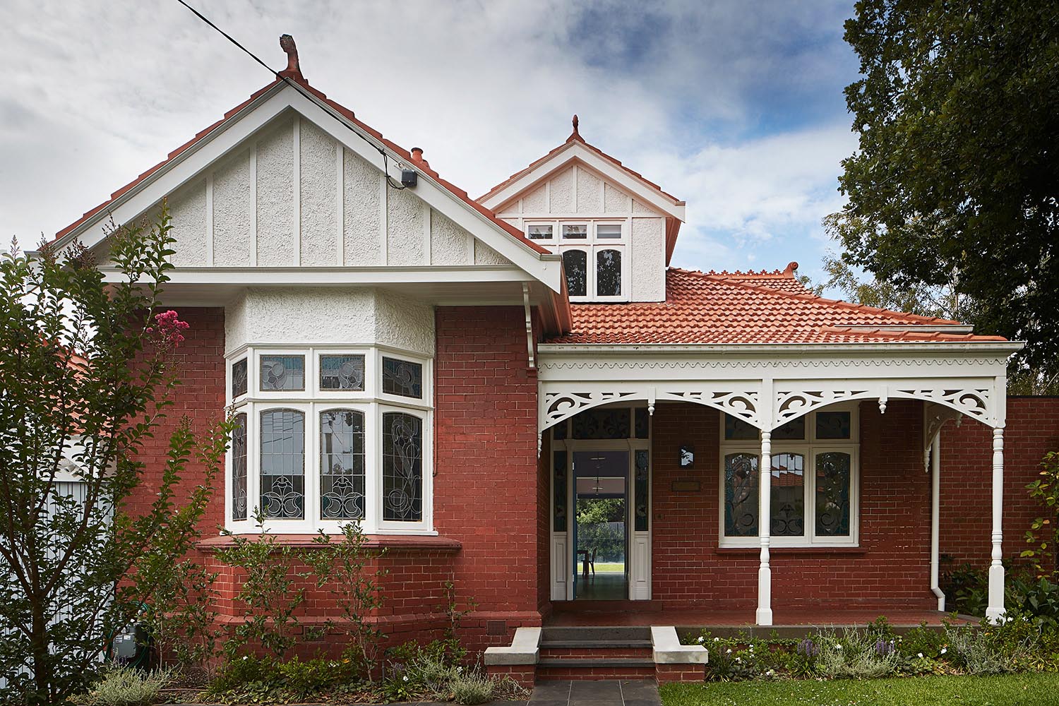 An Australian brick Federation house with a front porch.