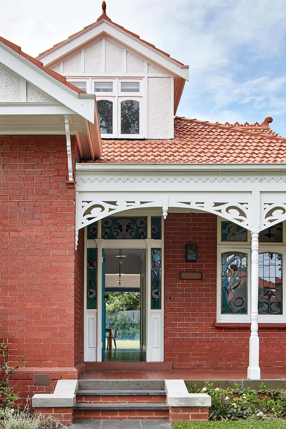 An Australian brick Federation house with a front porch.