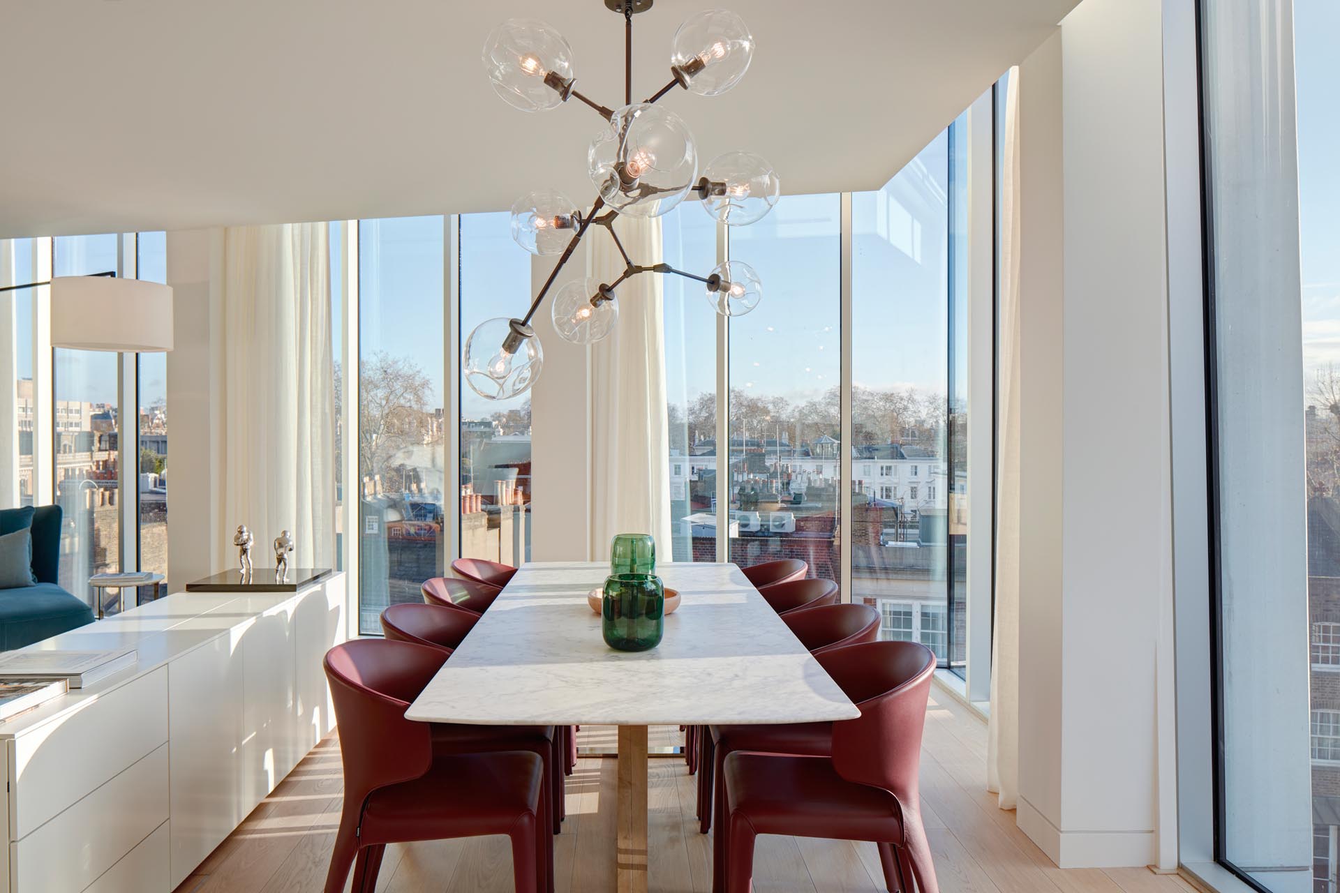 A modern open plan dining area with floor-to-ceiling windows.