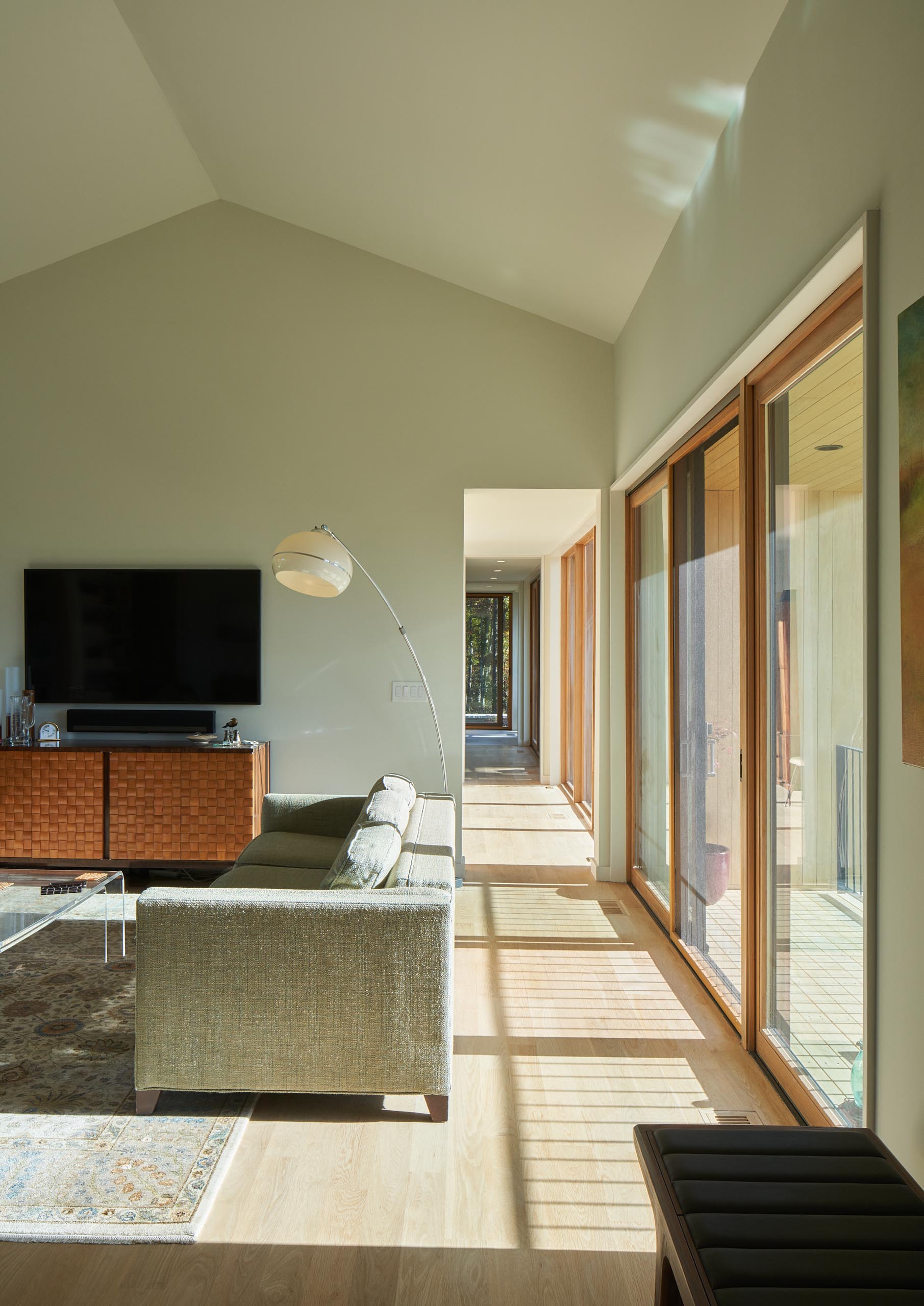 An open plan living room and dining area that has a vaulted ceiling, making the space feel larger.