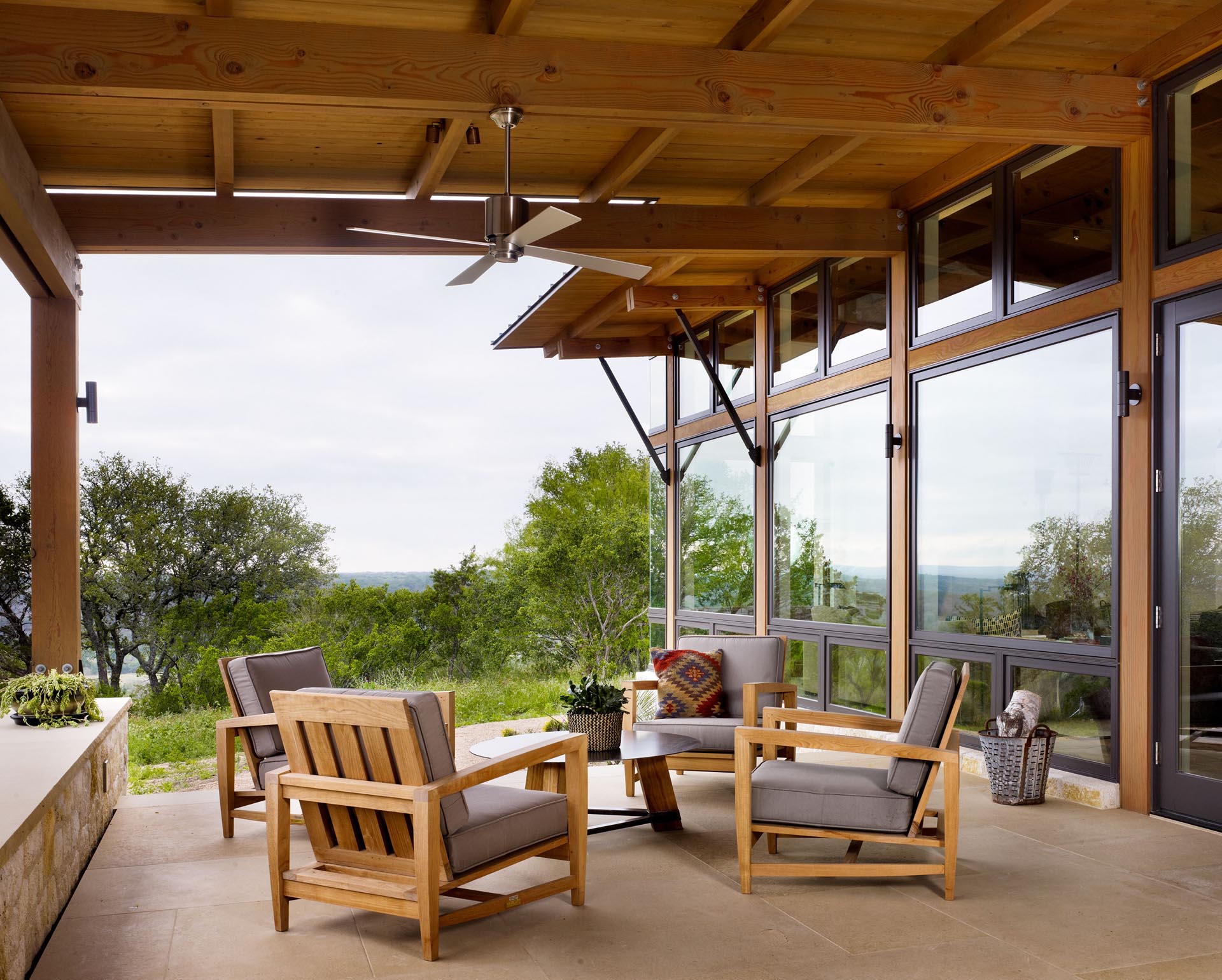 A covered porch with exposed wood beams.