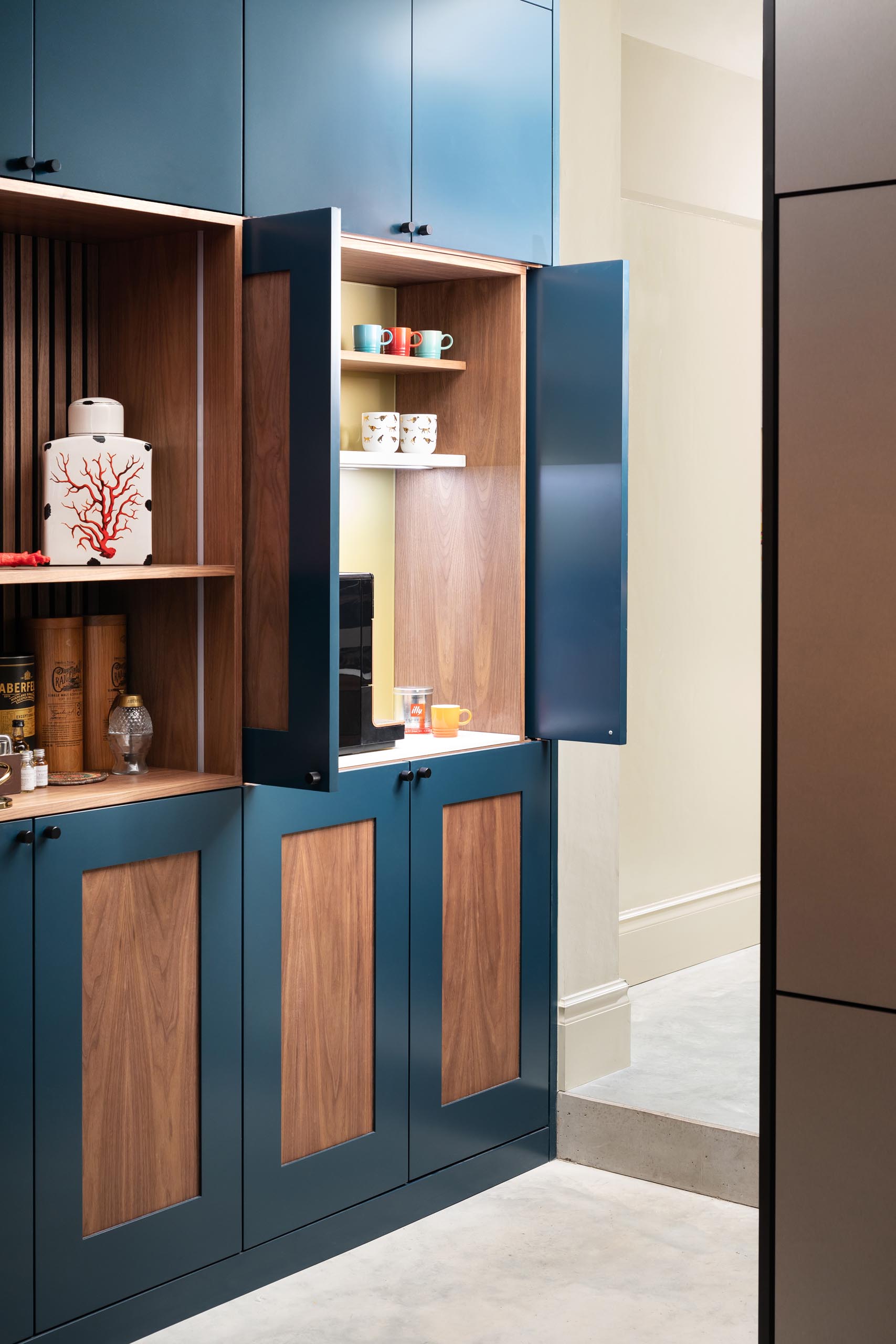 A custom designed cabinet with a coffee station hidden within.