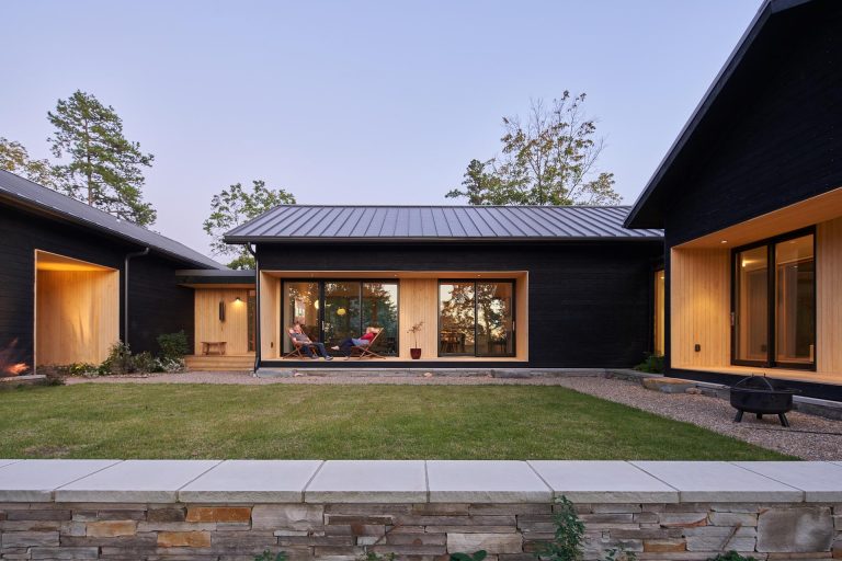 Light Wood Lined Alcoves Highlight Various Spaces On The Otherwise Dark Wood Exterior Of This Home