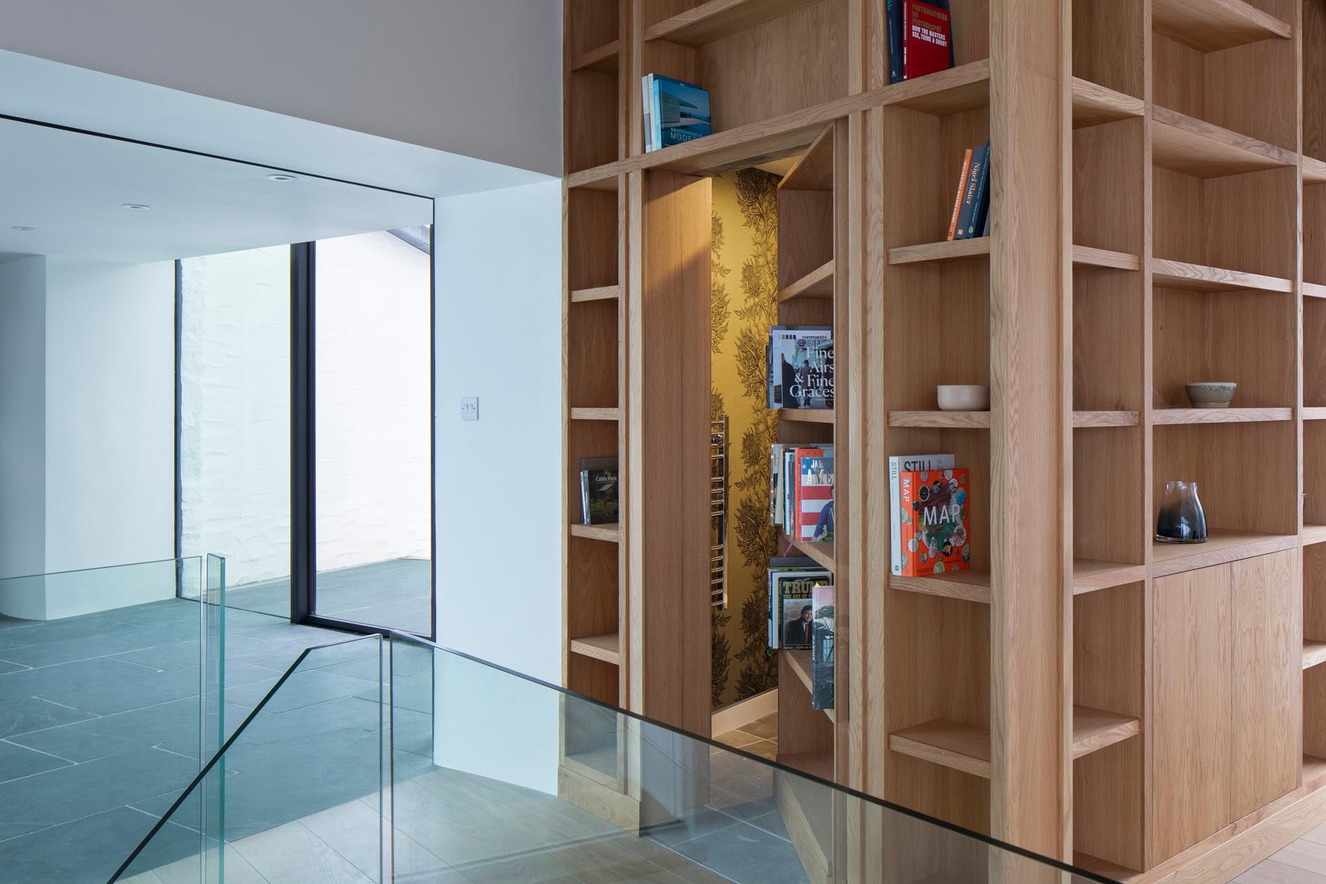 A wood bookshelf hides a powder room.