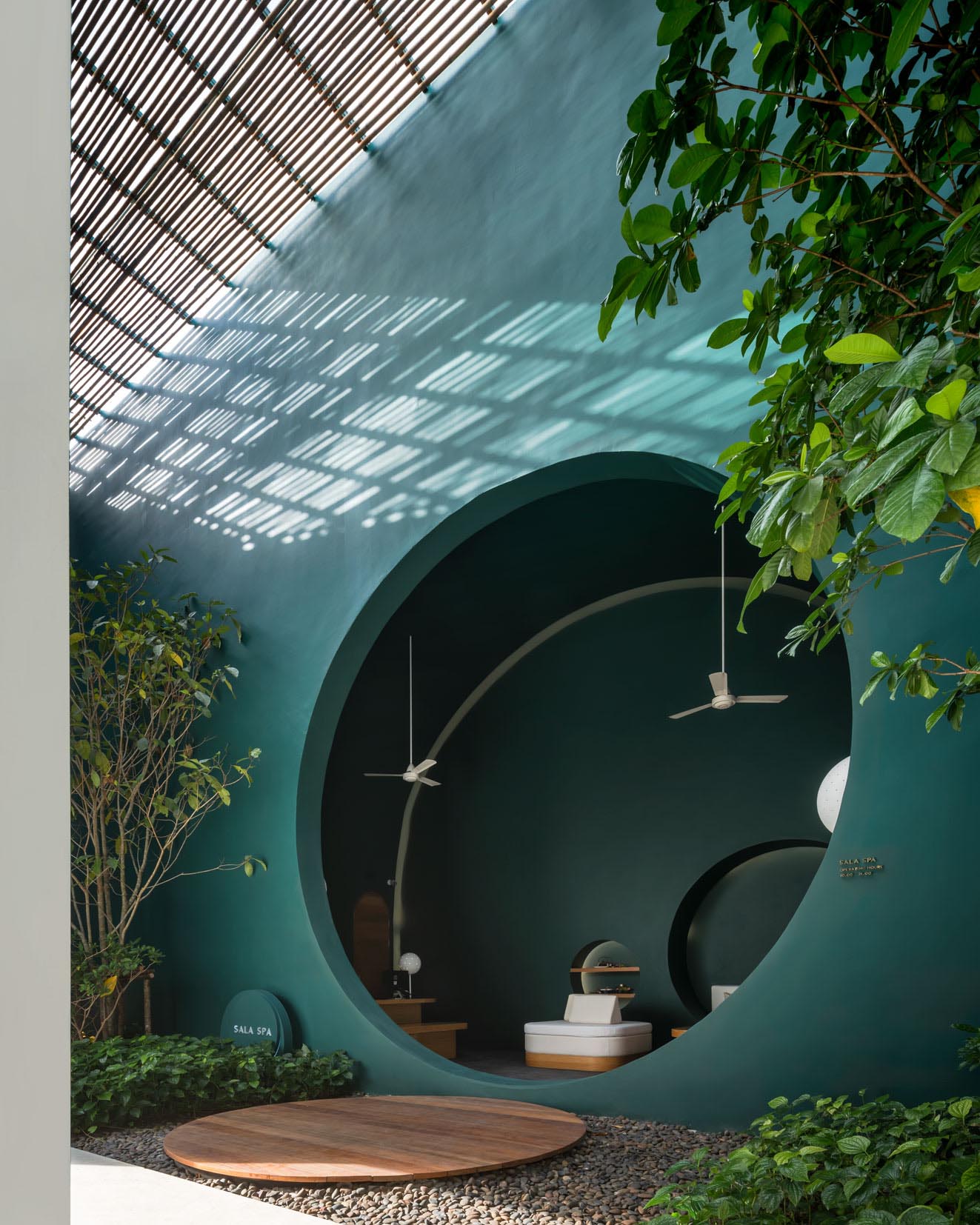 Dark green walls and a built-in seat in a modern hotel spa.