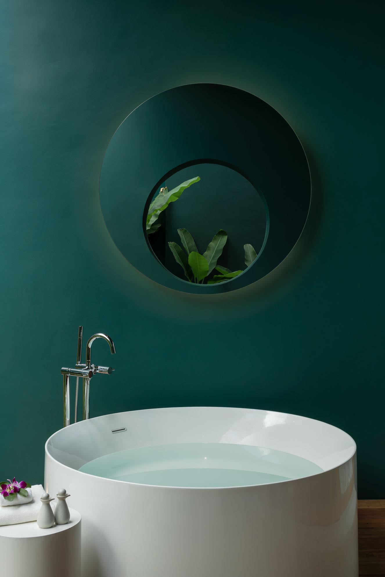 A bathroom with deep green walls.