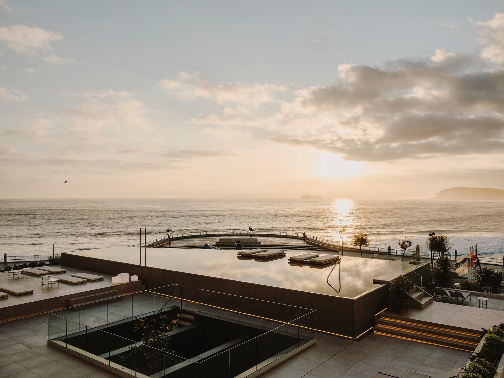 A modern hotel in Spain with a variety of levels dedicated to outdoor spaces and an infinity edge swimming pool.