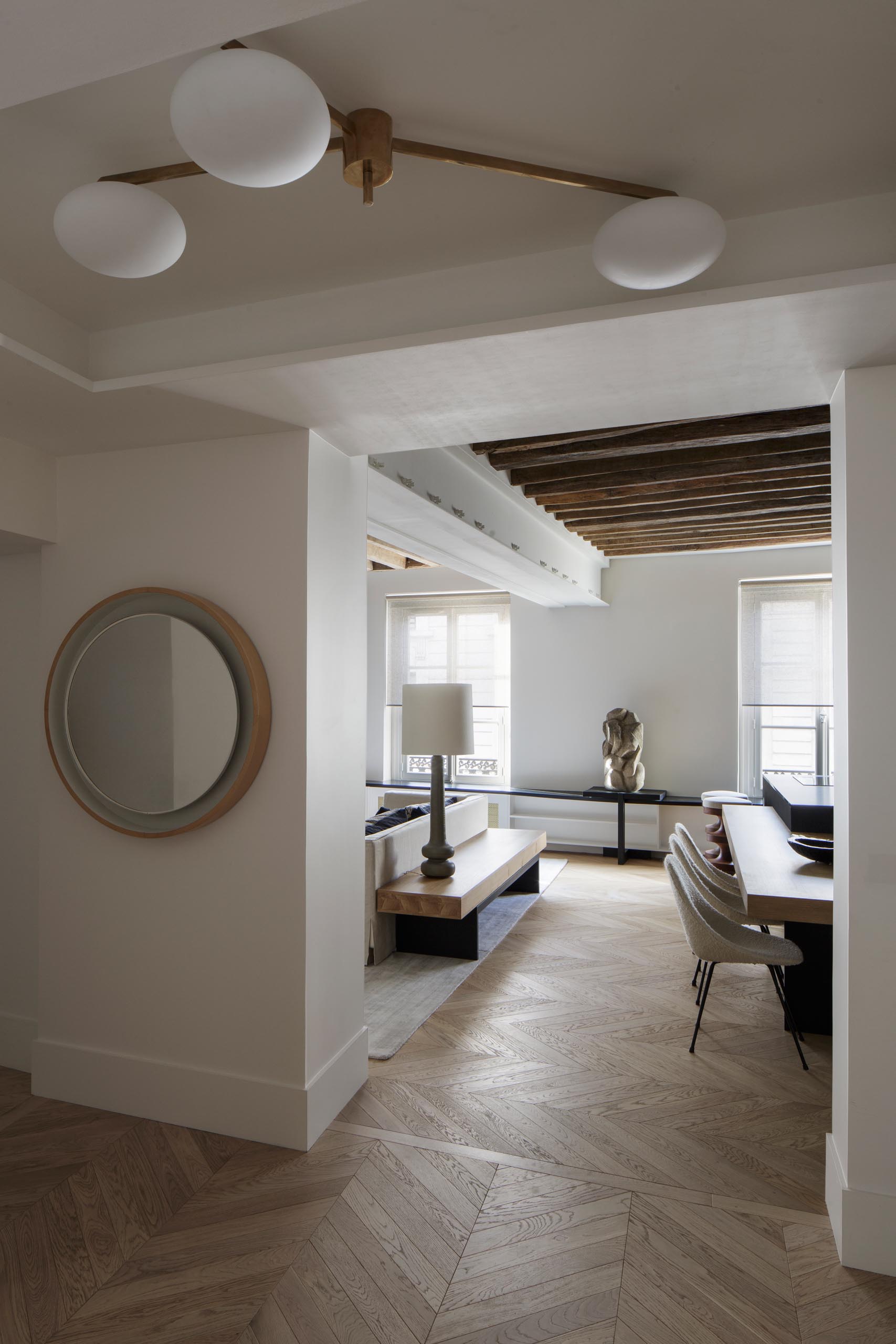 A modern entryway with light wood floors that flow through to the living room and kitchen.