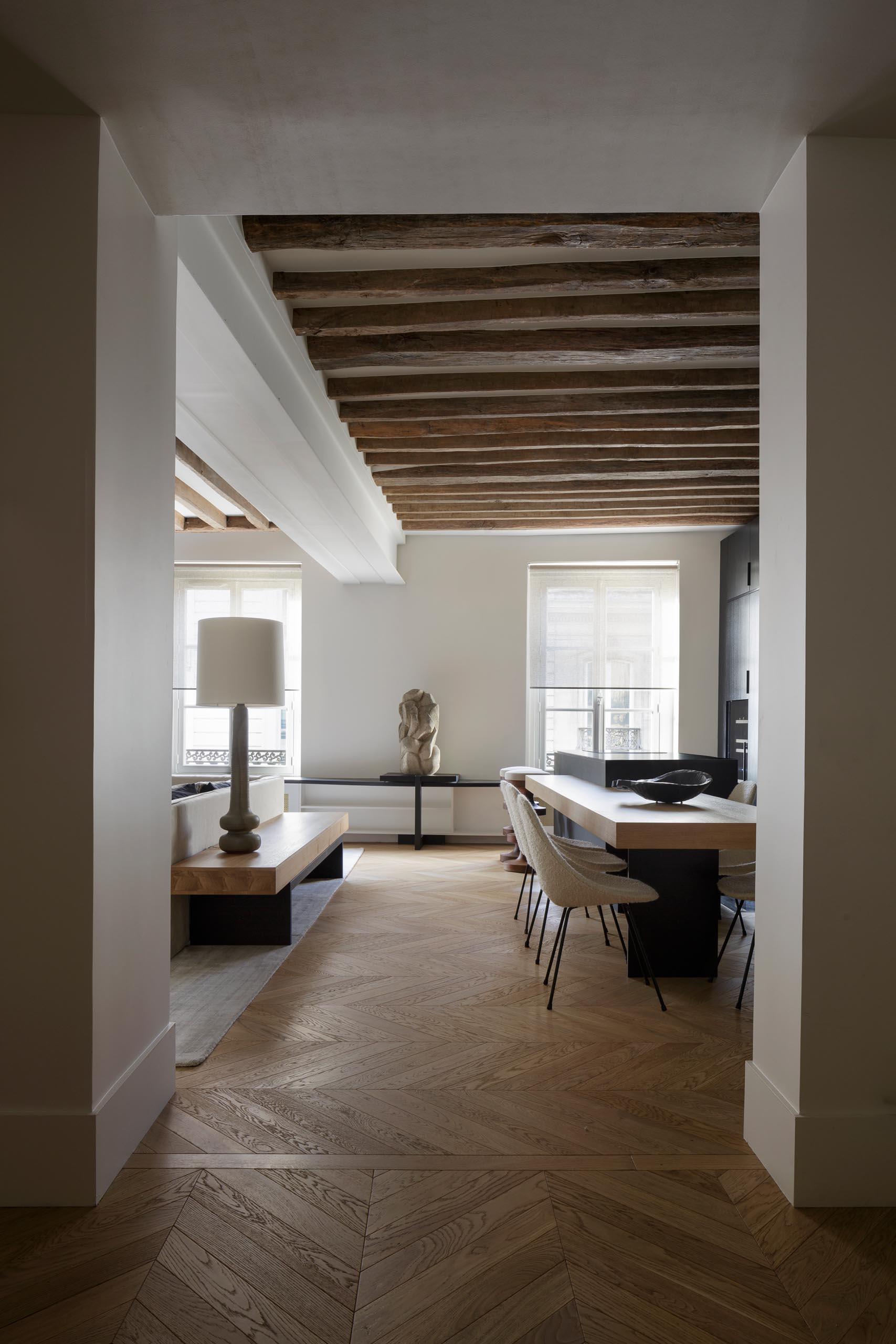 A modern entryway with light wood floors that flow through to the living room and kitchen.