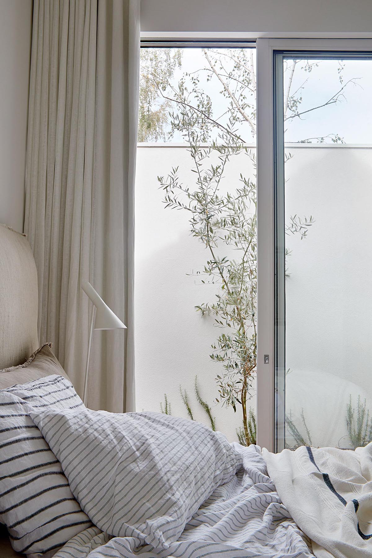 A modern bedroom with a natural color palette.