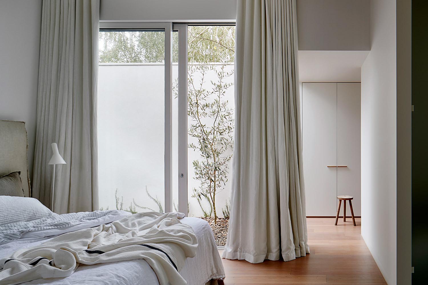 A modern bedroom with a natural color palette.