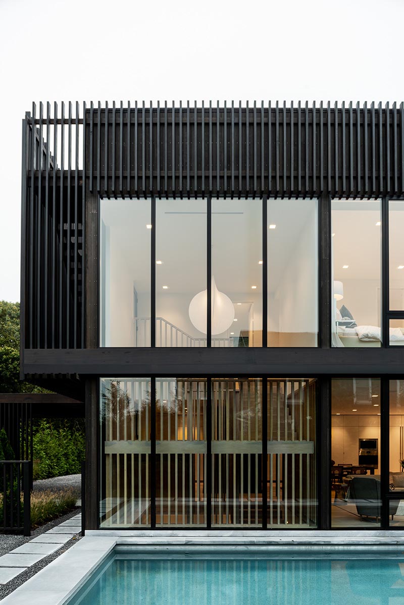 The rear of this modern home is fully glazed on both levels with custom Marvin Modern windows that create a strong connection between the home’s interiors and the outdoors.