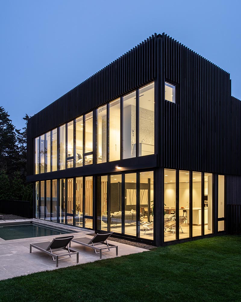 The rear of this modern home is fully glazed on both levels with custom Marvin Modern windows that create a strong connection between the home’s interiors and the outdoors.
